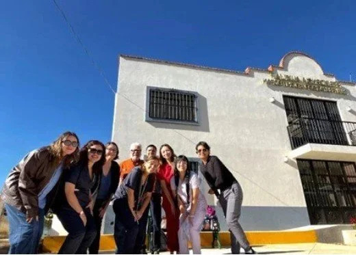 Group of people in front of a white building in Mexico