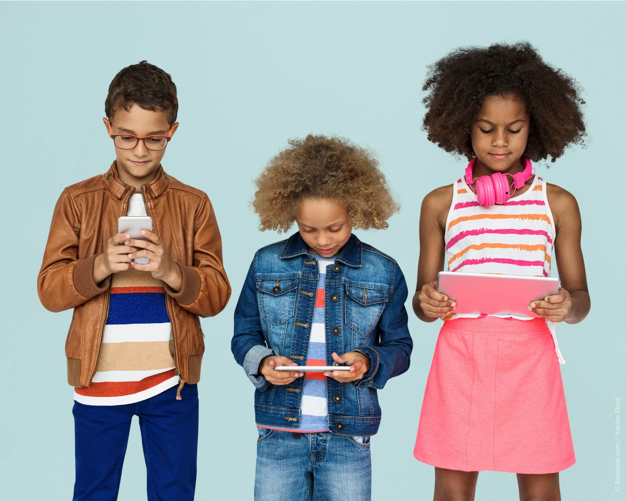 stock photo of 3 kids on their phones, standing in front of a light blue solid background
