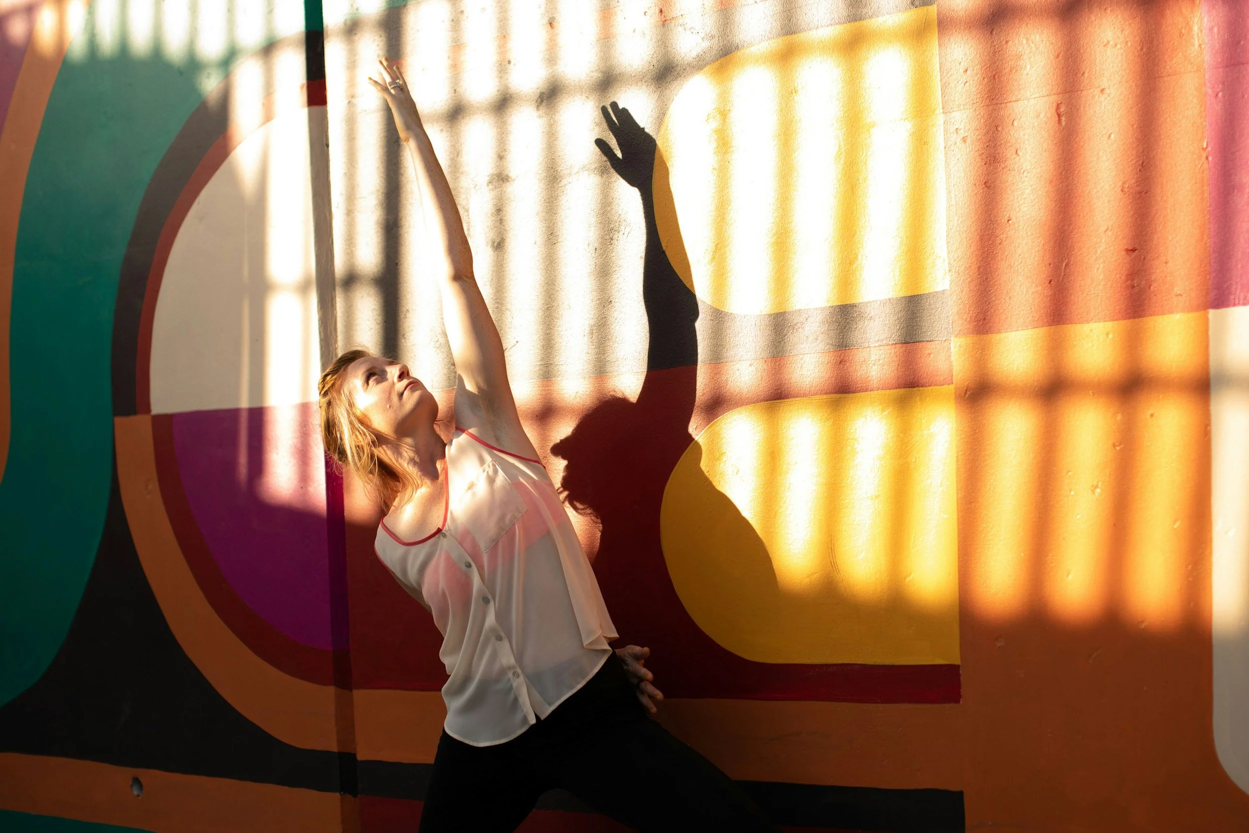 Caucasian, female-presenting client practicing reverse warrior pose.