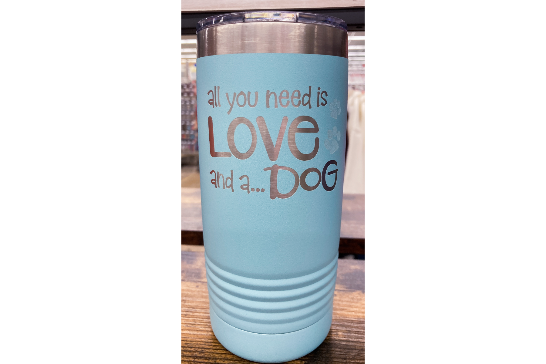 Image of Tumbler. Light Blue color with phrase All you need is love and a... Dog.