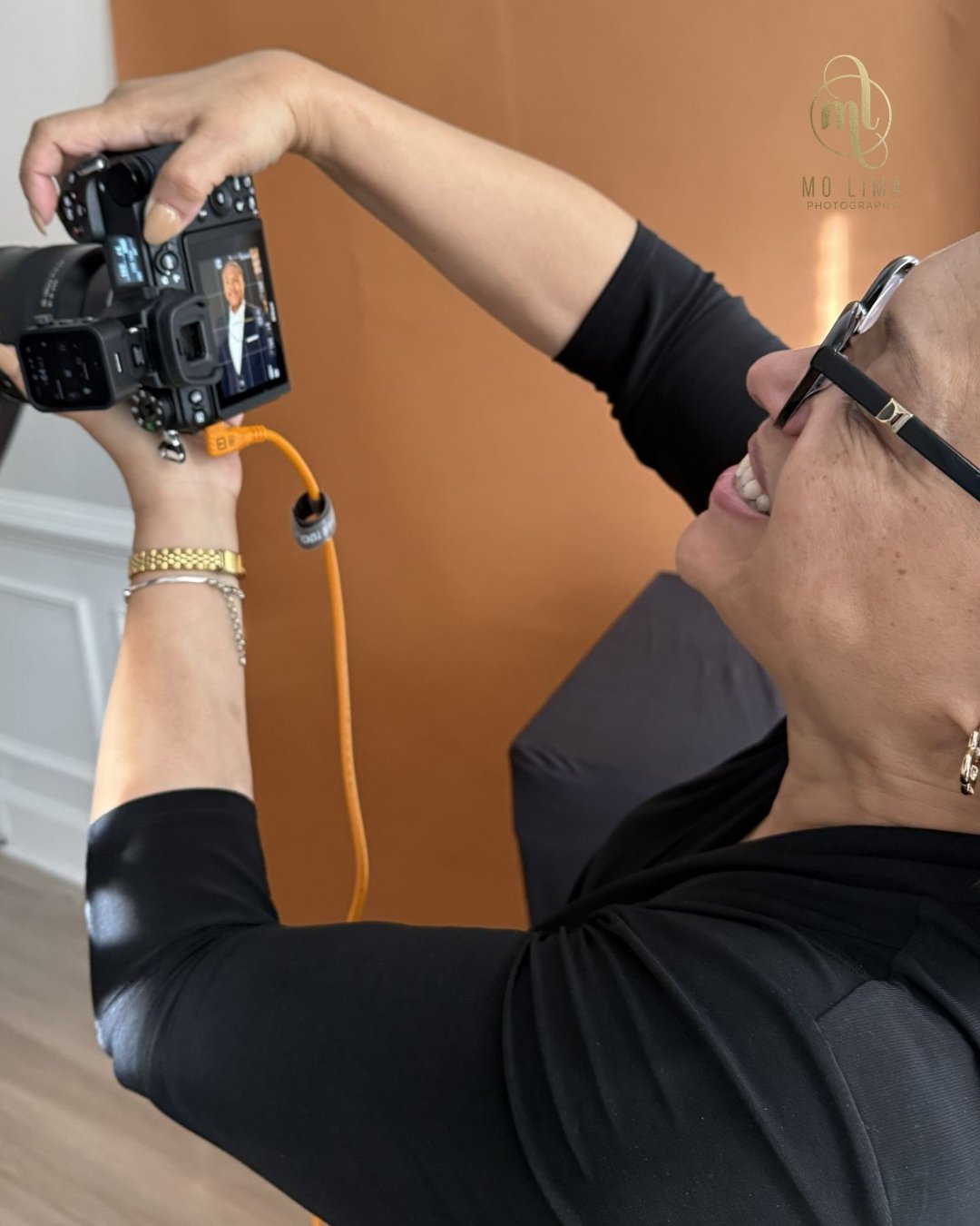 Nobody is afraid of a camera. They're afraid of being judged by one.
There's a difference.
The nervous laugh before a session. The "I'm just not photogenic" disclaimer that's offered. The way someone walks in, already apologizing for themse