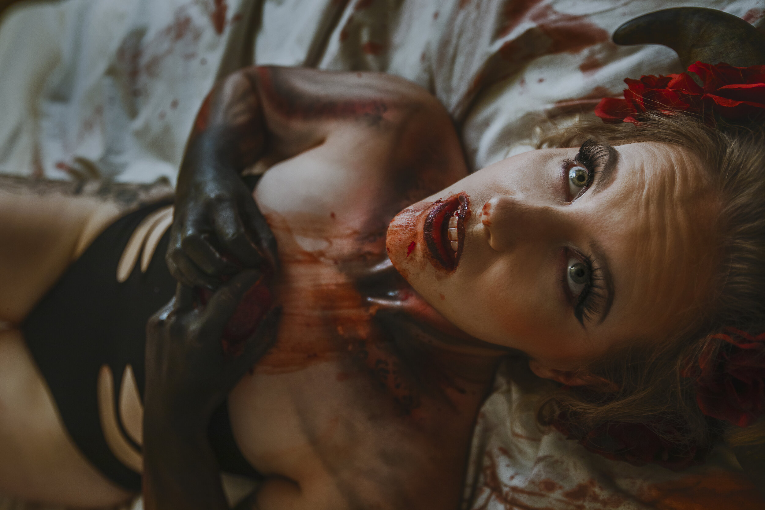 gory bloody woman holding a heart she has bitten fantasy succubus boudoir