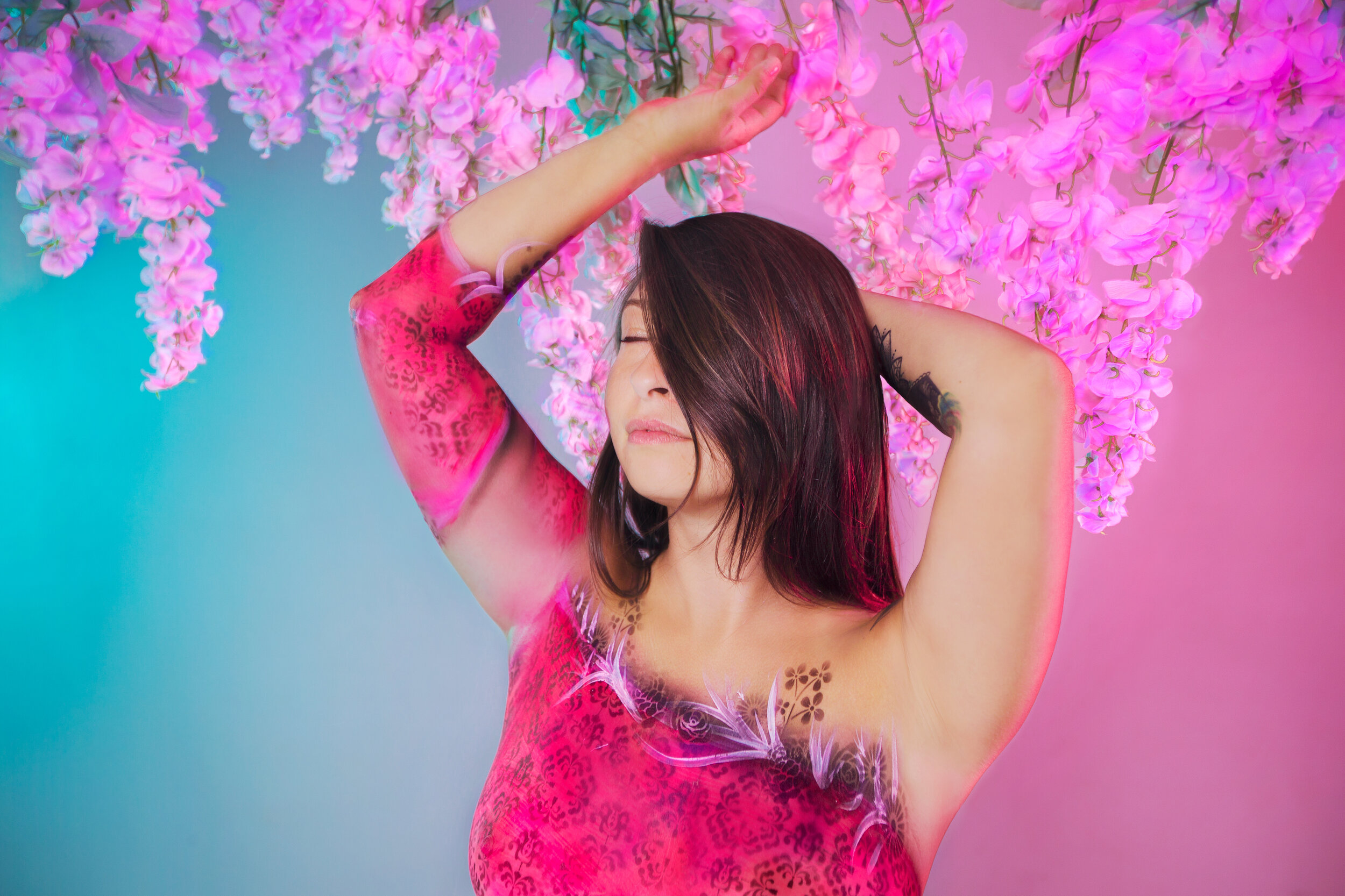 Bodypaint wrap wardrobe woman in colorful pink neon flowers