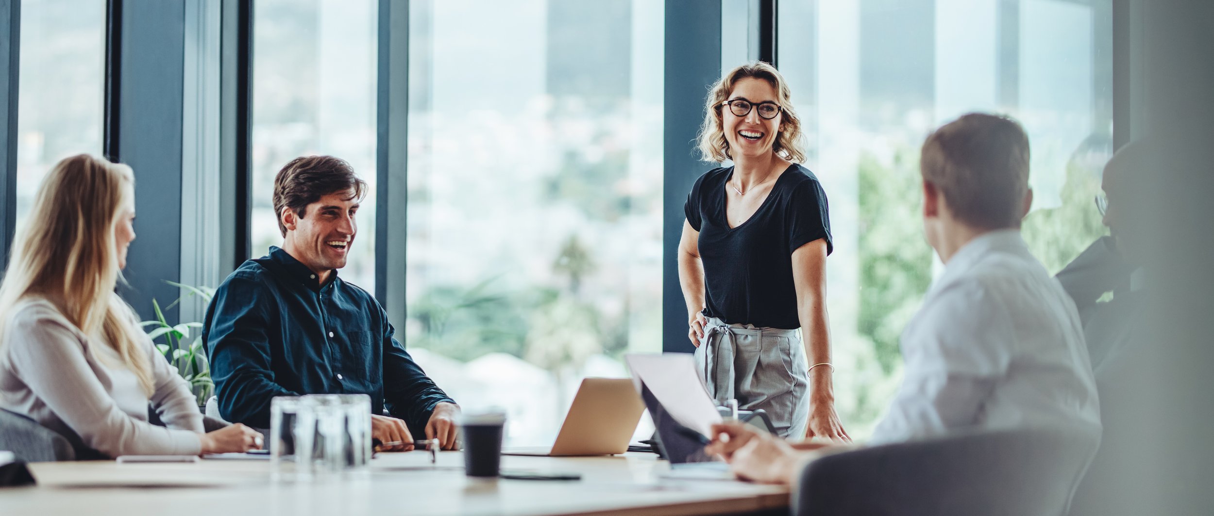 Colleagues in a workplace meeting discussing employee wellbeing
