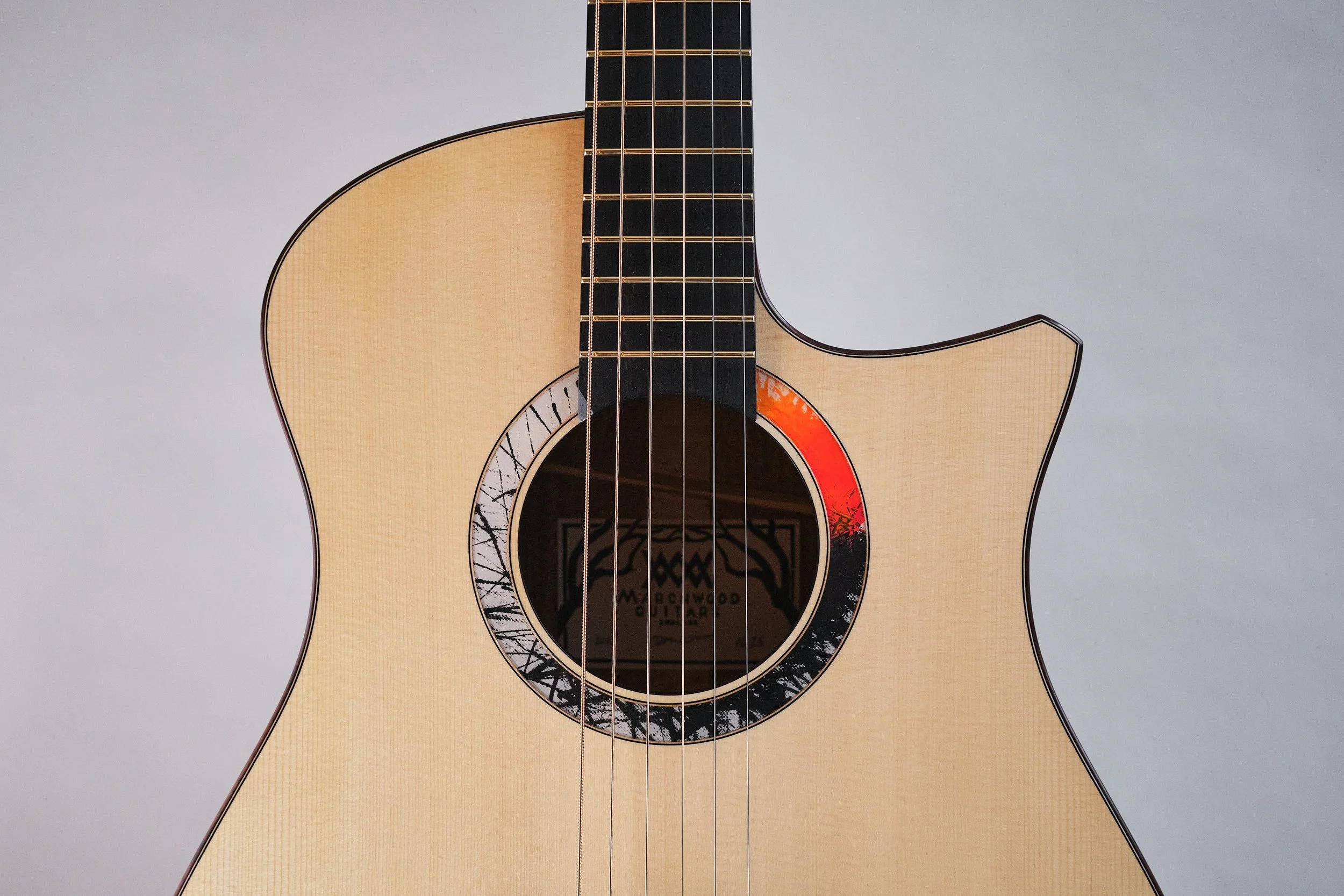 2025 OMc in Swiss spruce and English walnut. Ebony fingerboard, bridge and head plate. The rosette is hand painted by the client.  