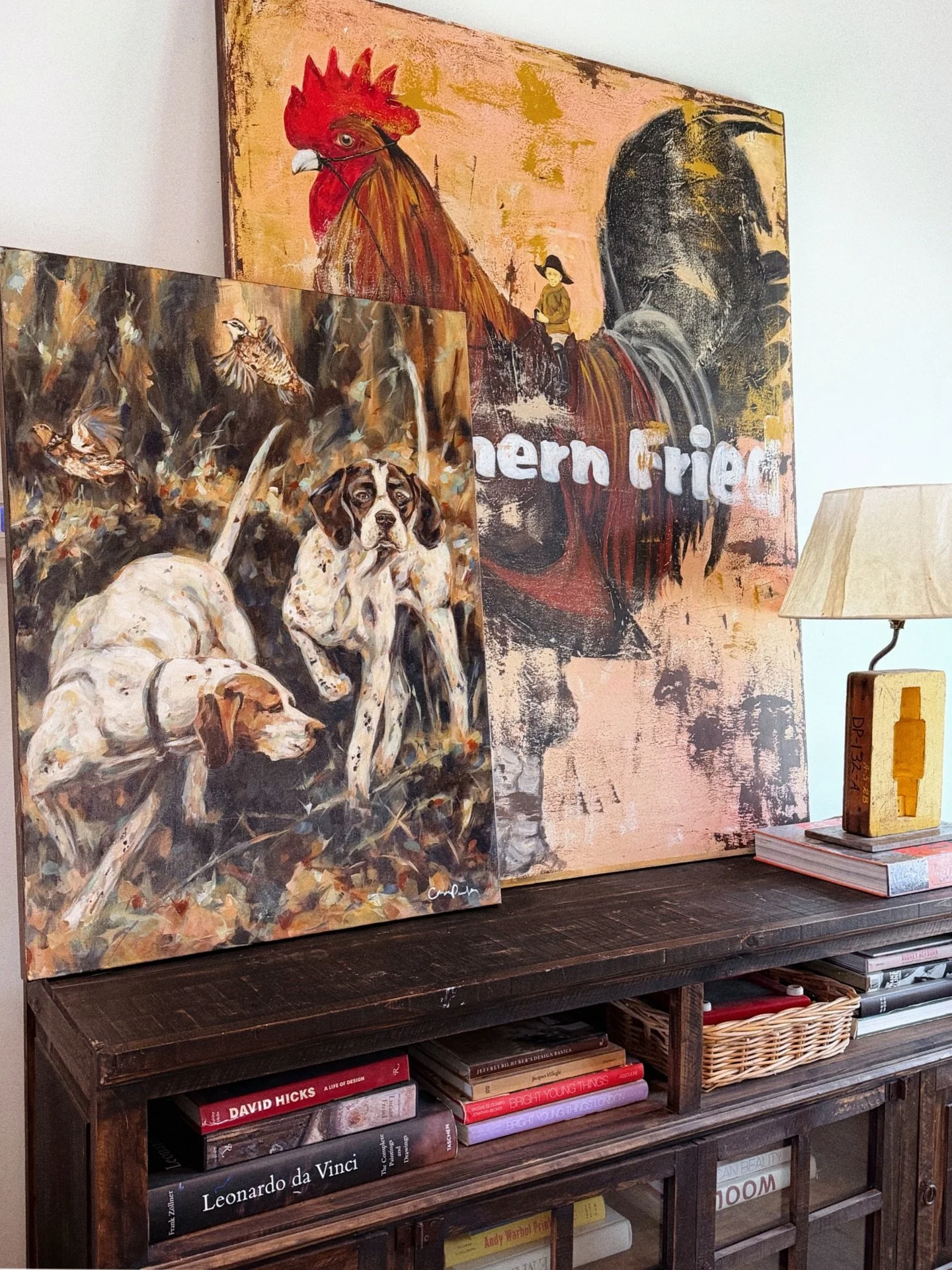 In good company! My latest hunting dog duo propped up beside a friend's painting, Southern Fried, by Cedric Smith.  I've always been drawn to coral contrasted with dark color.  If you look closely, happy colors are used in this pointer study so it ap