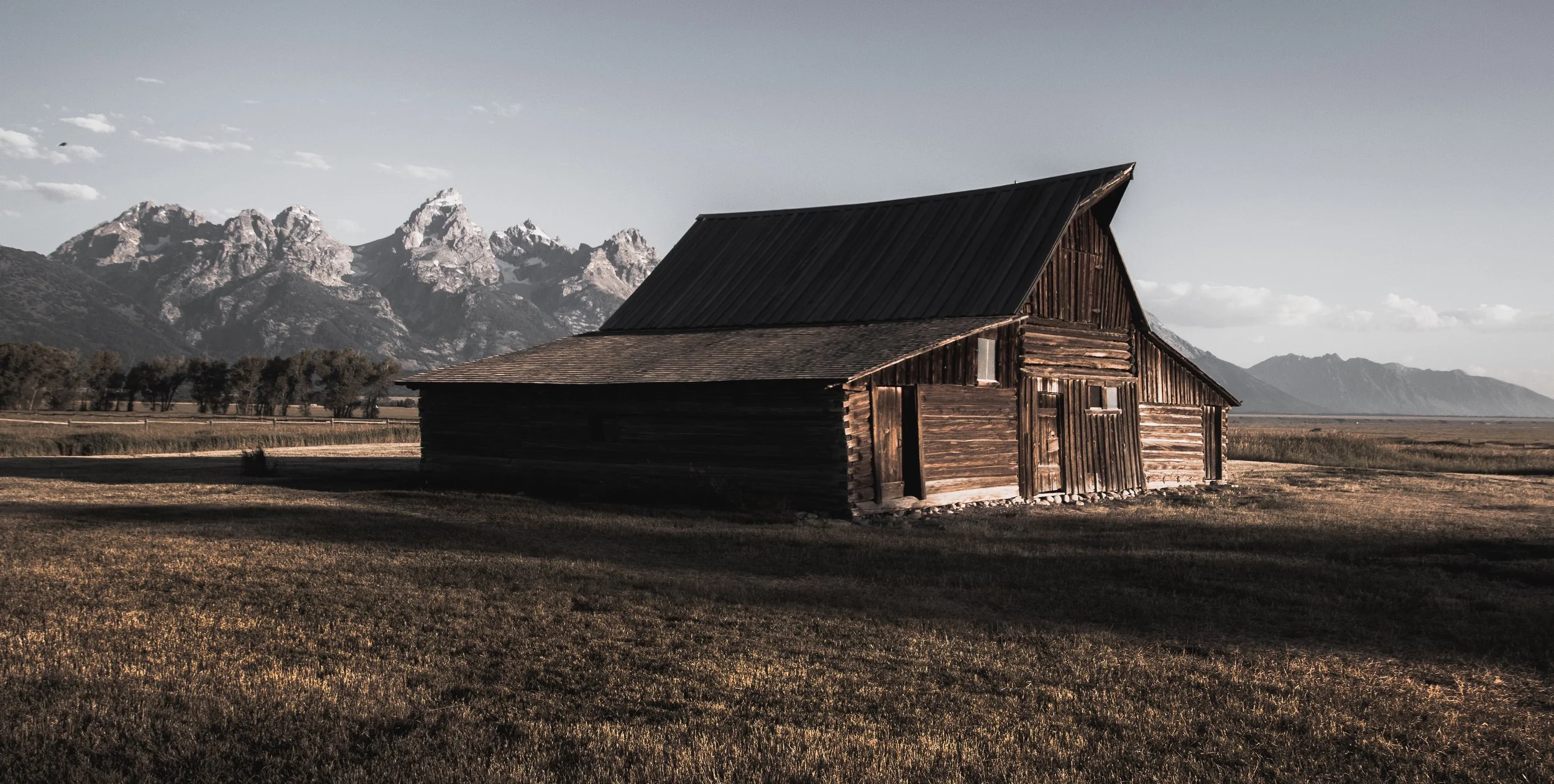 The most famous barn in America, T.A. Moulten Barn with the majestic Grand Teton mountain range in the background photographed by Lyall Penley, another Penley family artist.