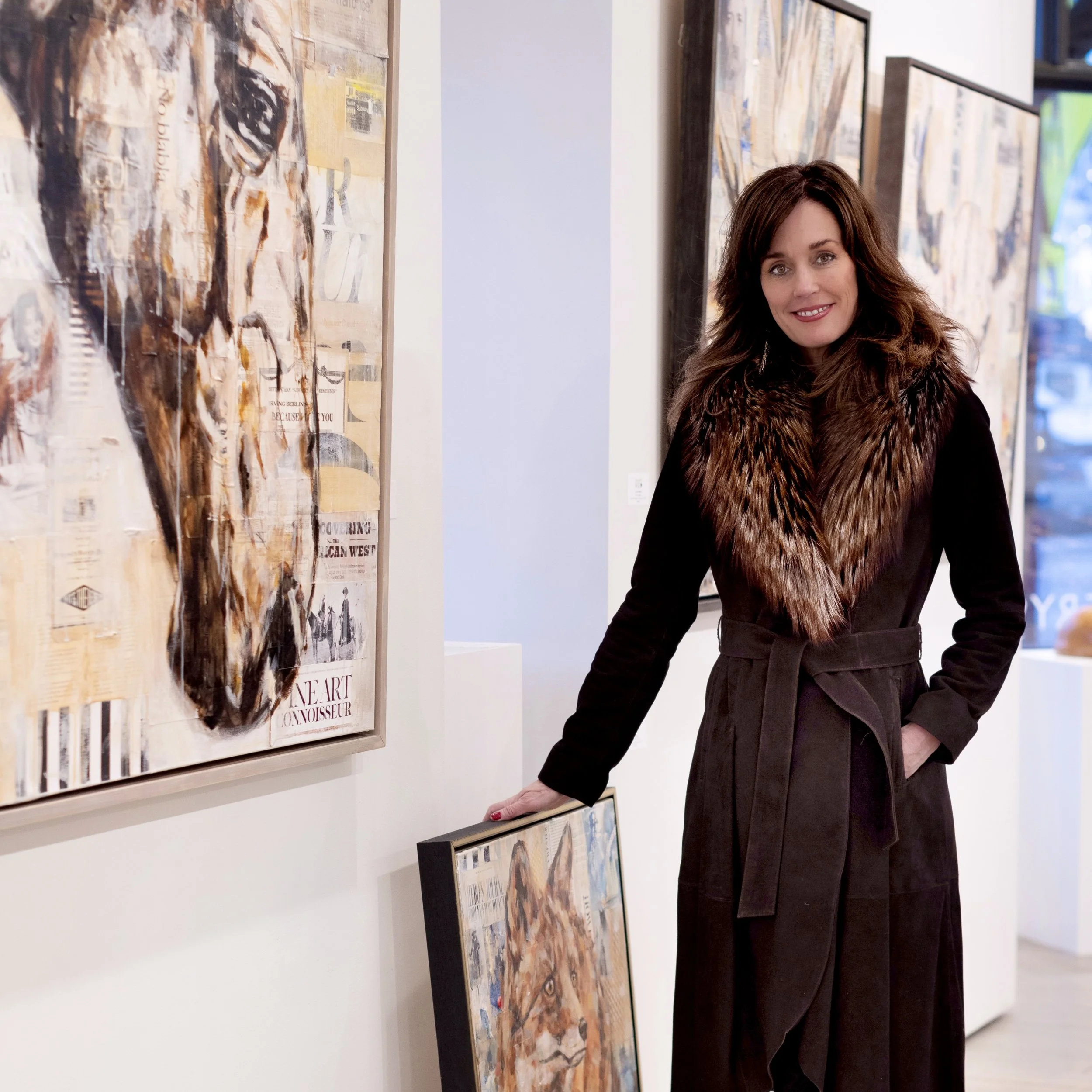 Carrie Penley artist standing by her contemporary western mixed media paintings at the art gallery, Gallery Wild, in Jackson Hole.