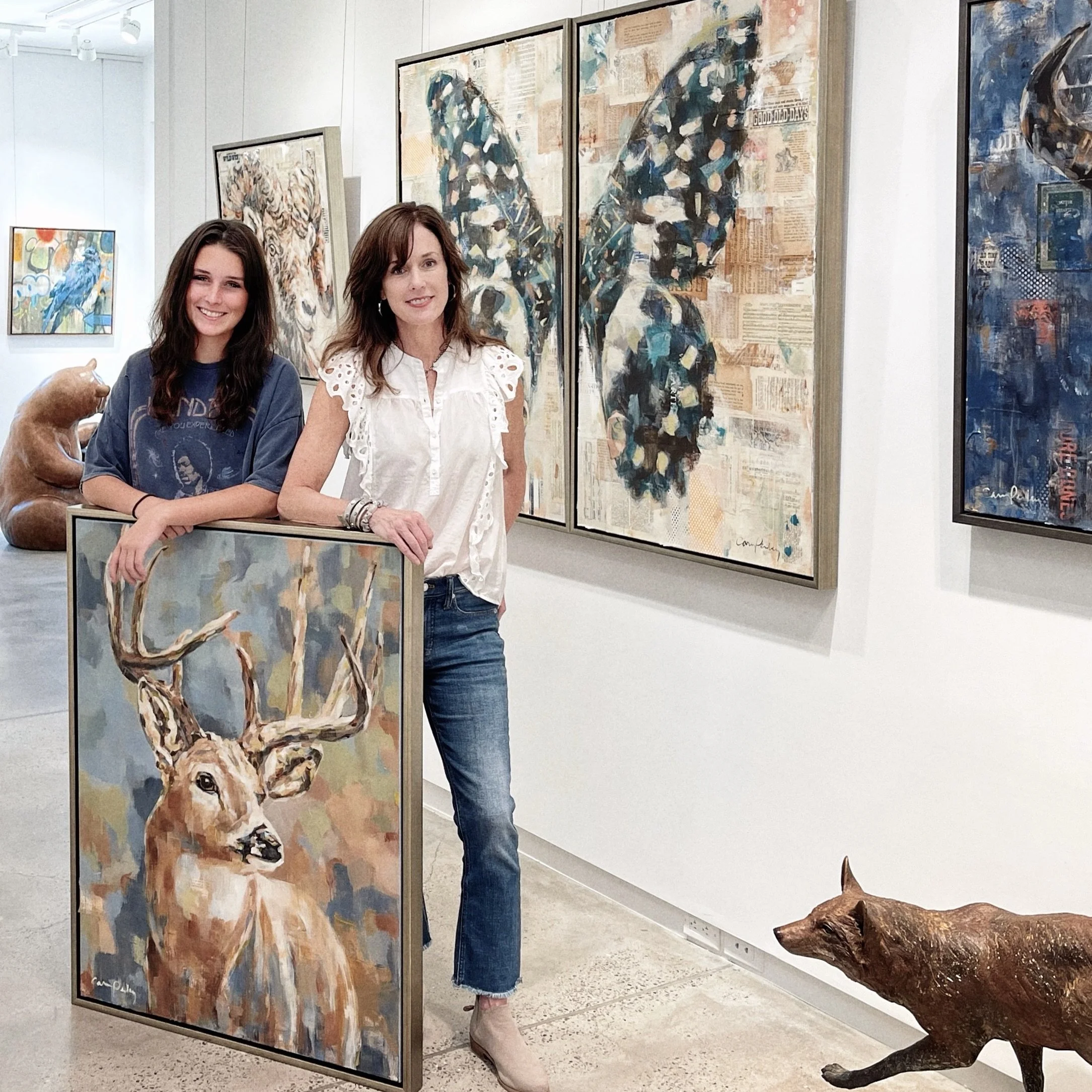Carrie Penley and her daughter Abbey, also a Penley family artist,  in Santa Fe at an art gallery with Carrie Penley's contemporary western paintings.