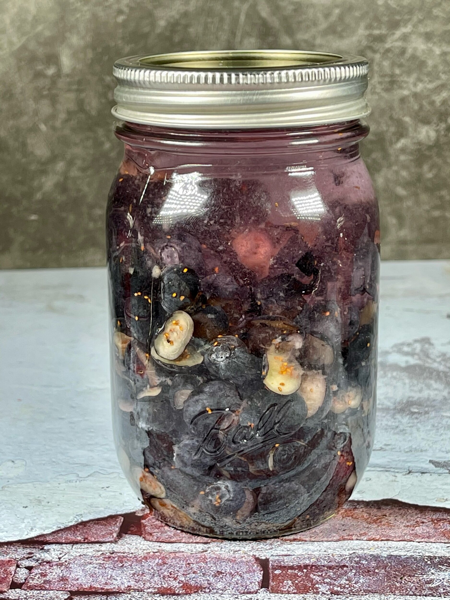  Chopped blueberries back in its jar and filled with vodka, making sure they are all submerged. 