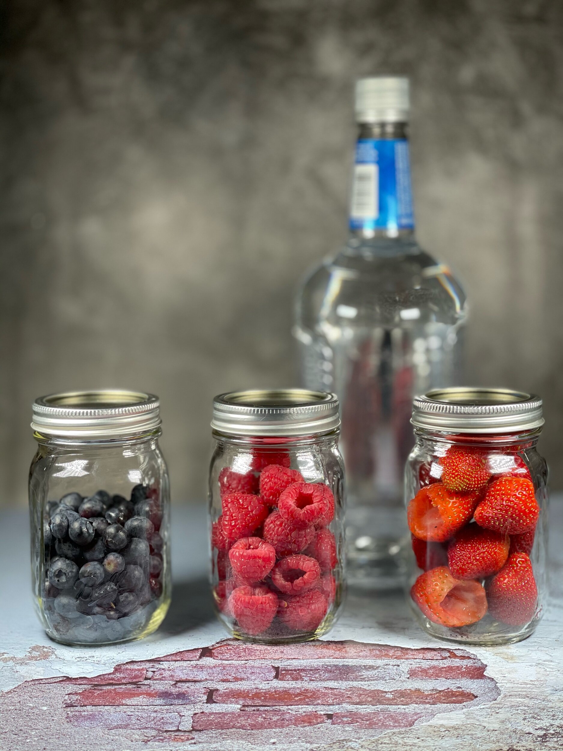  Jars of blueberries, raspberries and strawberries showing how many I use before chopping them up. 