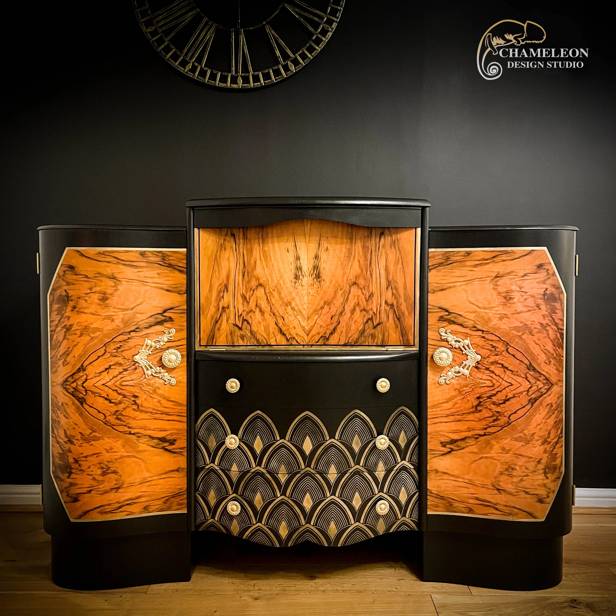 Font of Art Deco drinks cabinet. Painted with black mineral paint. 3 drawers with gold stencil. Doors shows wood grain.
