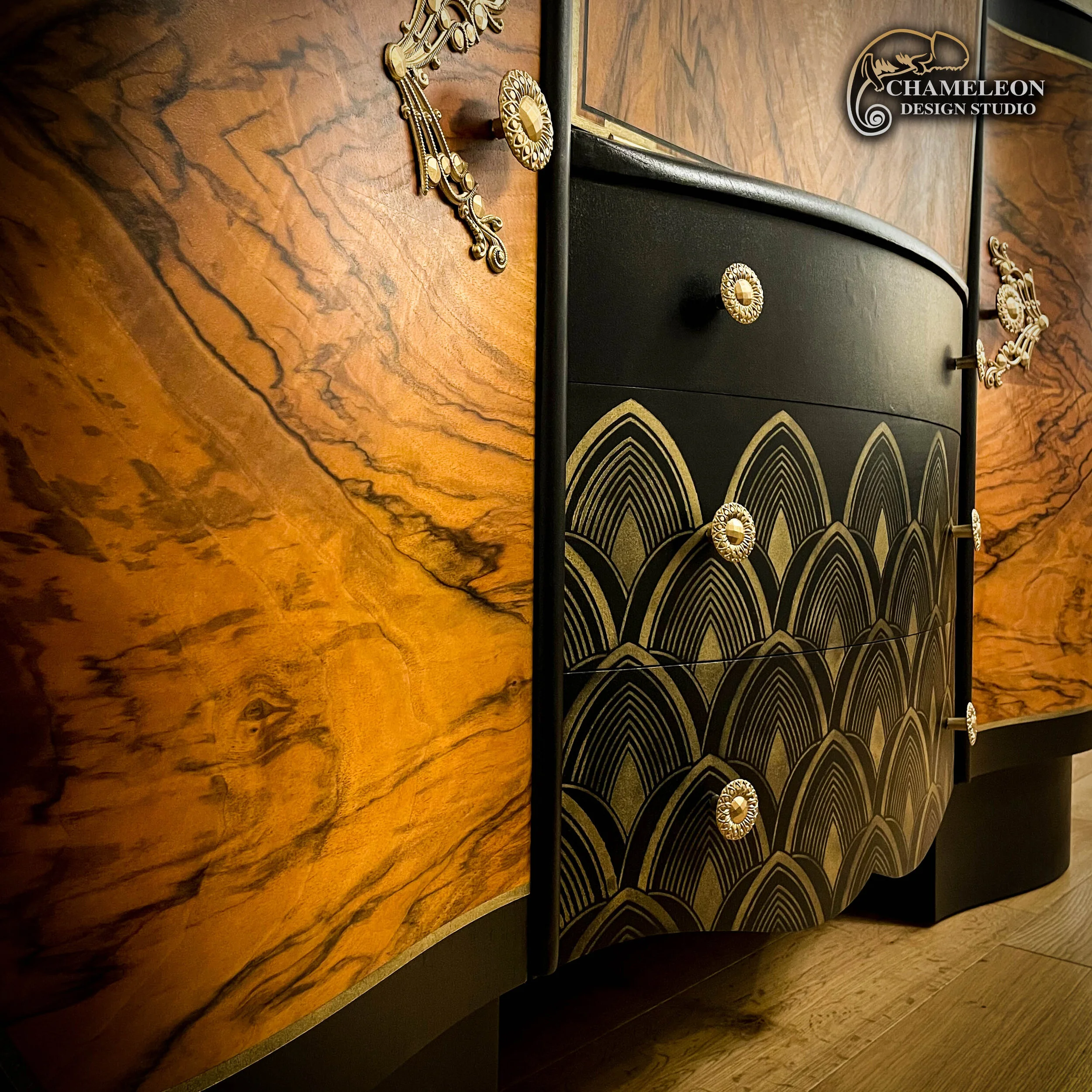Font of Art Deco drinks cabinet. Painted in black, stencilled drawers and gold handles