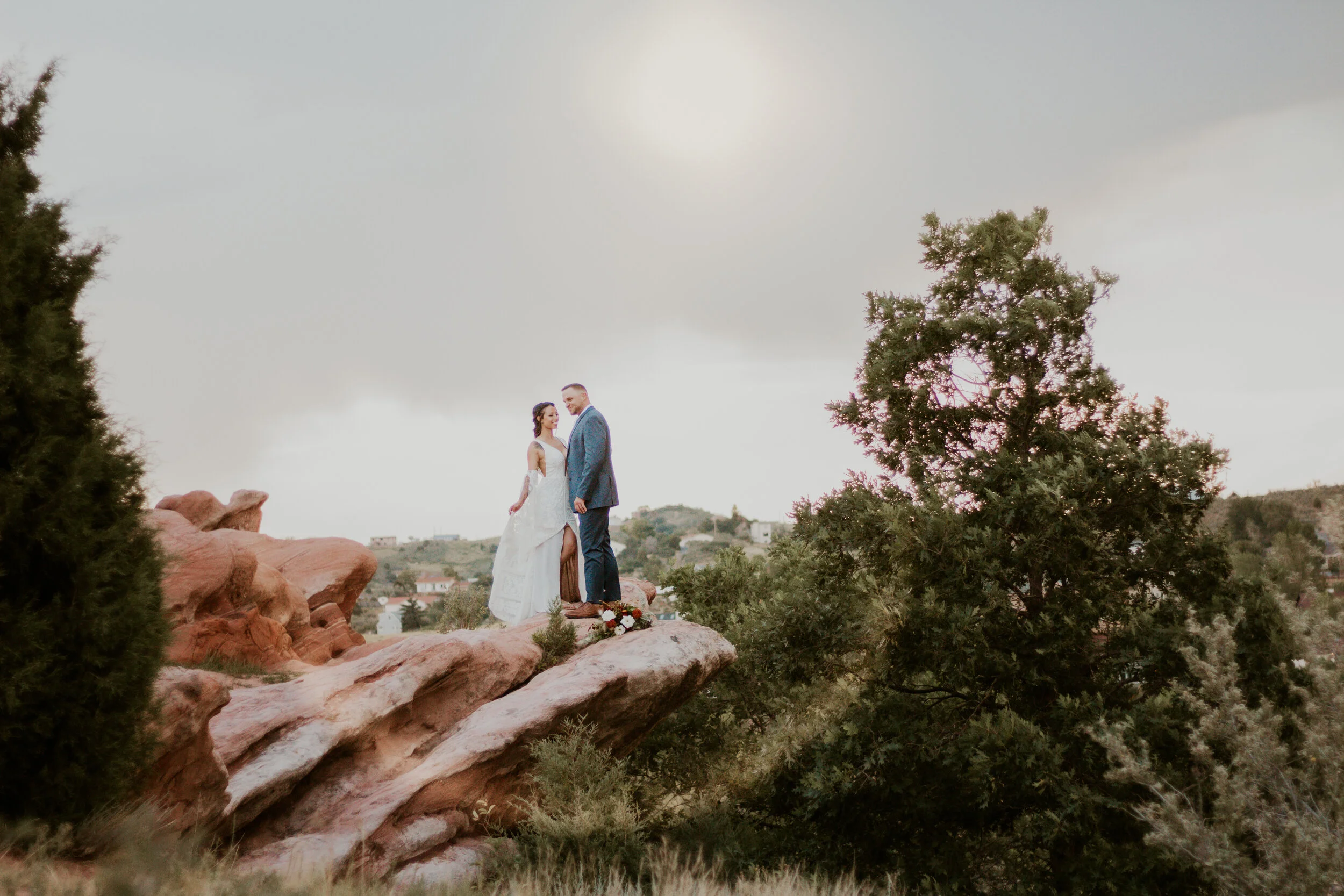 Posed on a peak of Colorado’s Red Rocks, this bohemian-styled couple poses for their wedding portraits by Dawn Louise Photography. Colorado Red Rock wedding ceremony, Colorado Red Rocks elopement, professional denver colorado wedding photographer, b…