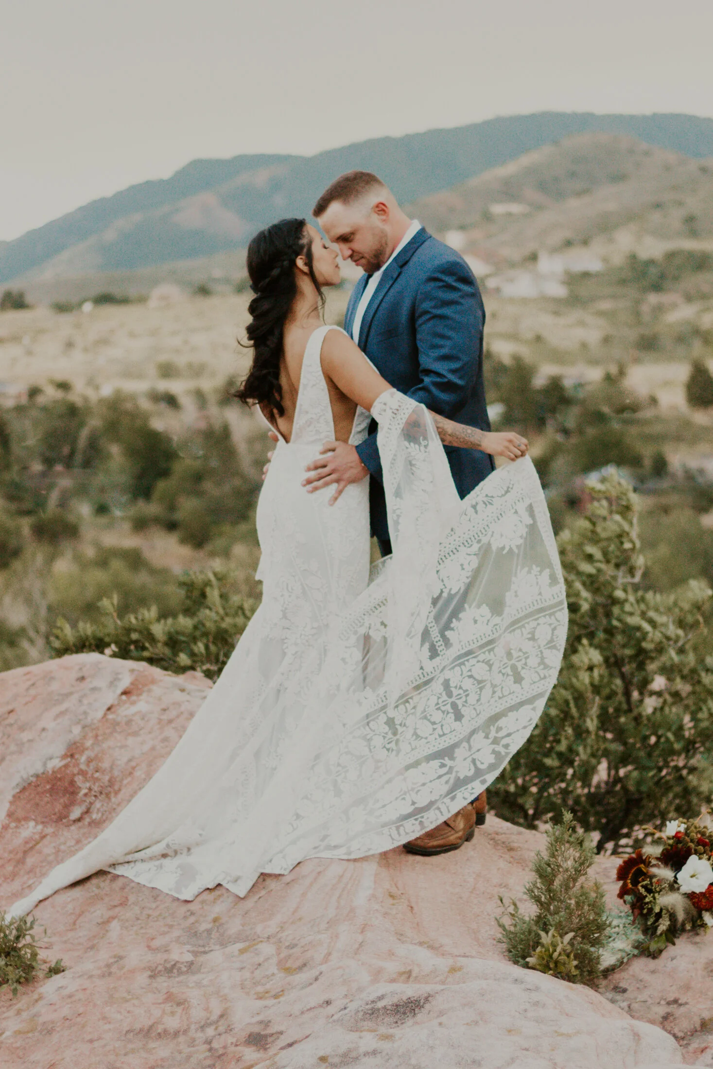  With the gorgeous Colorado Rocky Mountains in the backdrop, Dawn Louise Photography captures this bohemian couple at the peak of their Colorado Red Rock wedding ceremony. bohemian styled bride, long half up bridal hair, colorado rocky mountain weddi