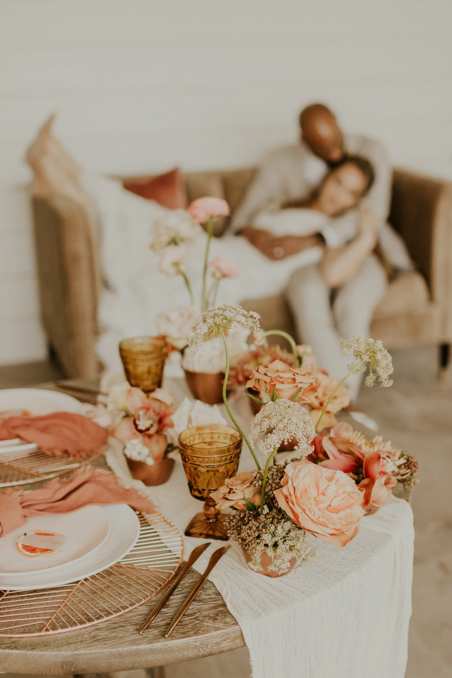  Showing off the details of the table place settings with a view of the bride and groom during a boho inspired styled wedding shoot with Dawn Louise Photography in Colorado. Denver boulder wedding photographer table place settings centerpiece flowers