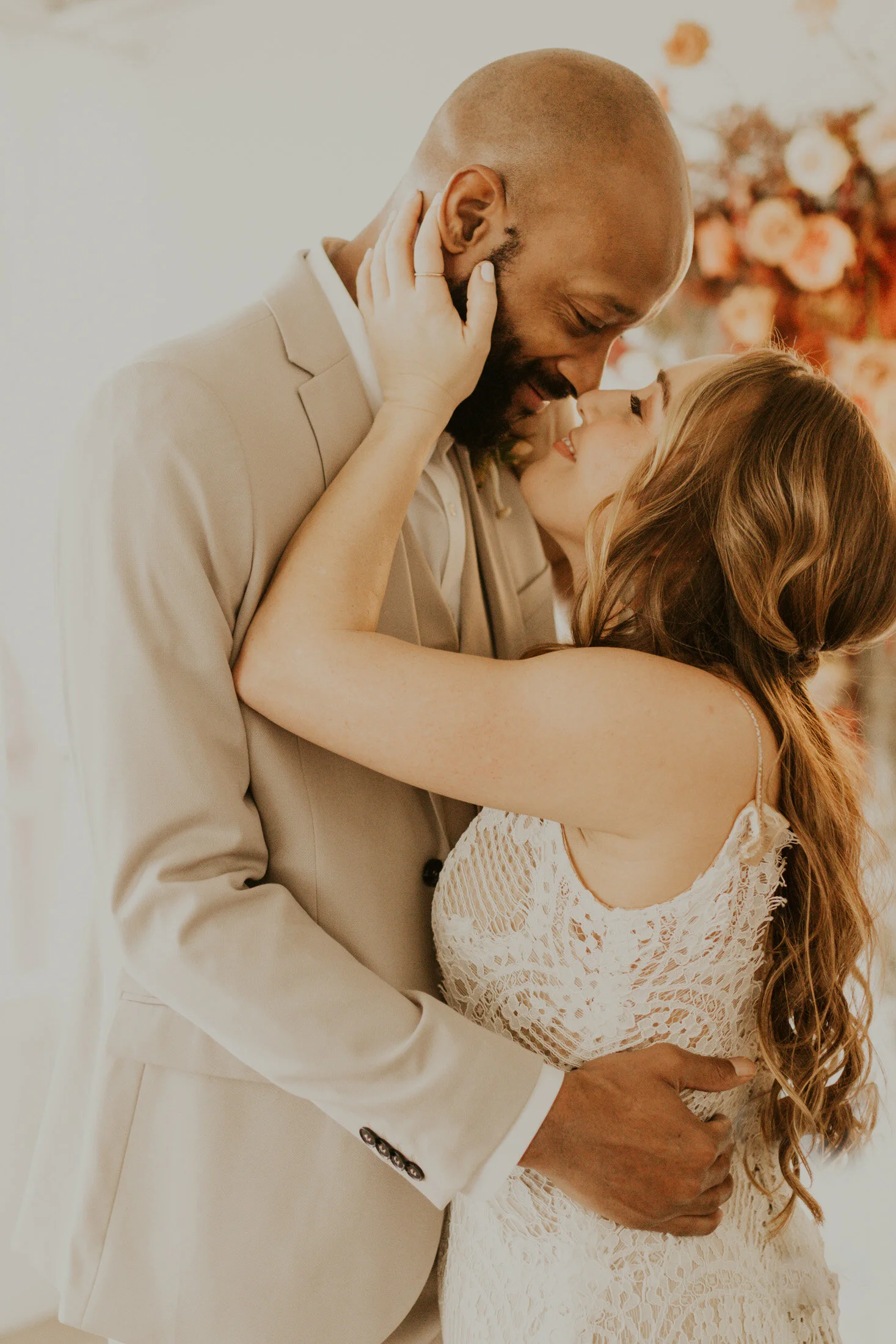  The happy couple shares a moment together during this beautiful boho wedding styled shoot in Boulder, Colorado with Dawn Louise Photography. Bride and groom denver colorado wedding photographer boho inspired flower backdrop bohemian white lace weddi
