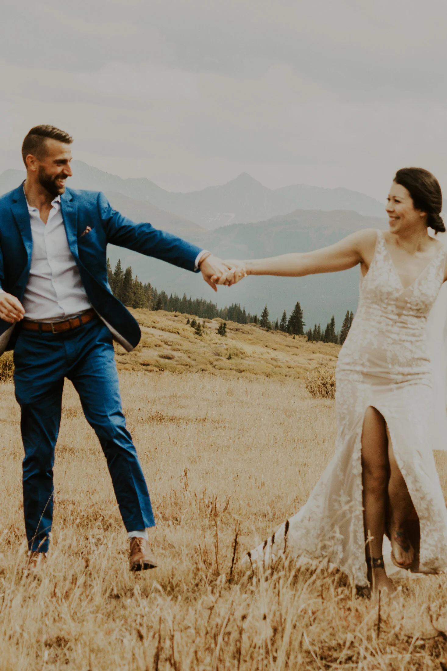  A playful moment captured of the bride and groom at their cost friendly elopement in the mountains of Colorado with Dawn Louise Photography. bride and groom candid moments adventure wedding denver wedding photographer dawn louise photos #elopement #