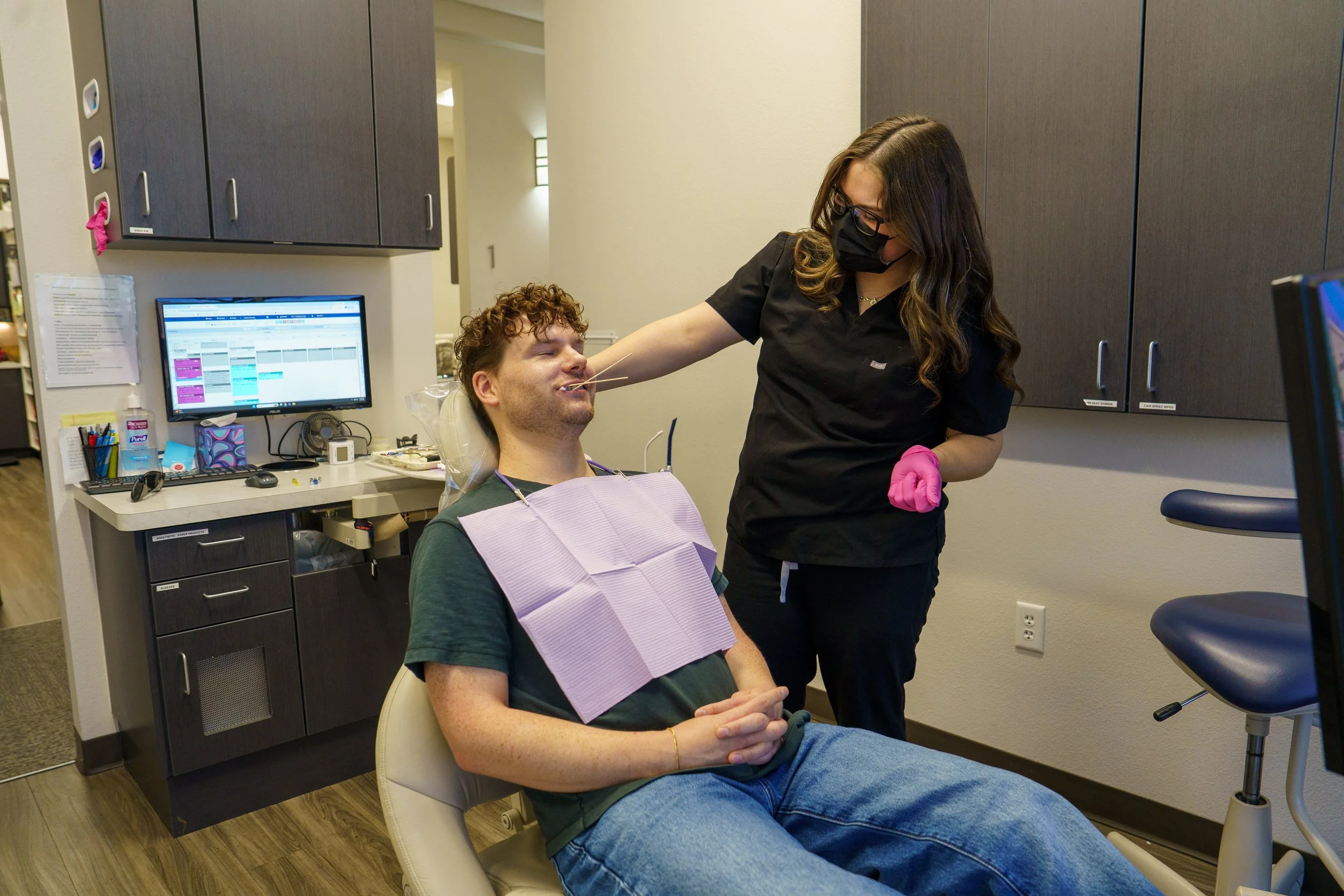 Dental professional working with a patient during a corporate healthcare photography session