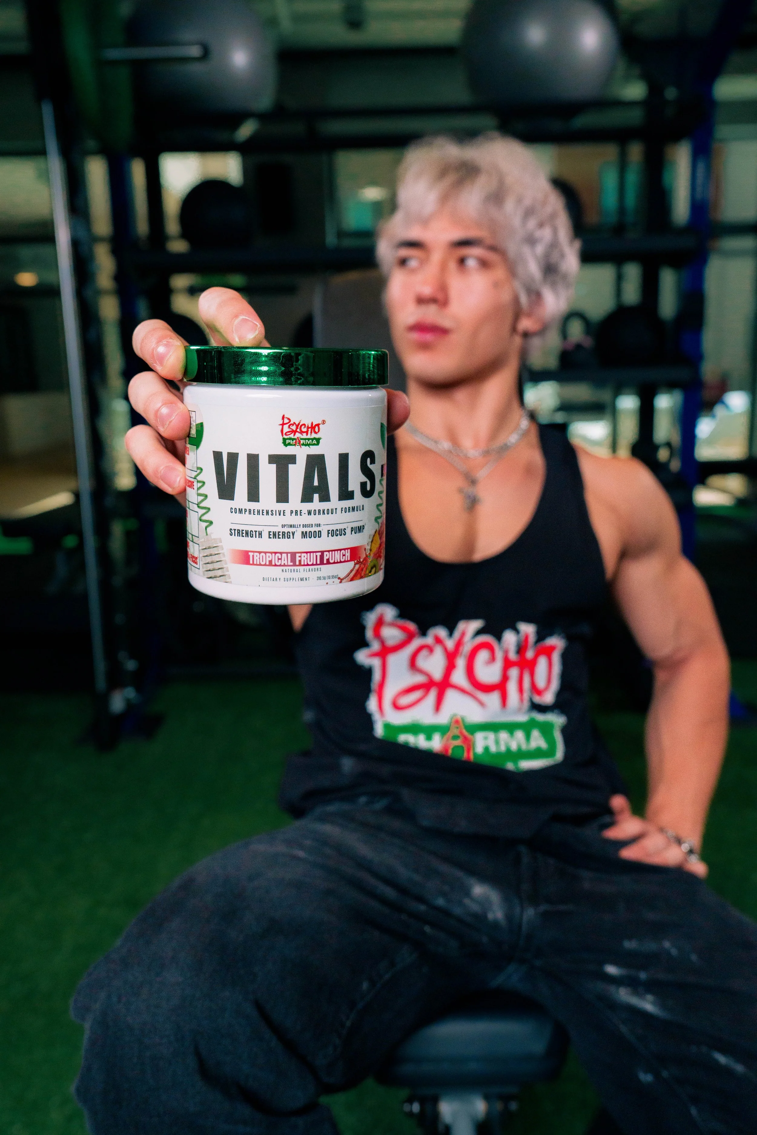 Psycho Pharma Vitals supplement photographed with a fitness athlete in a Phoenix gym