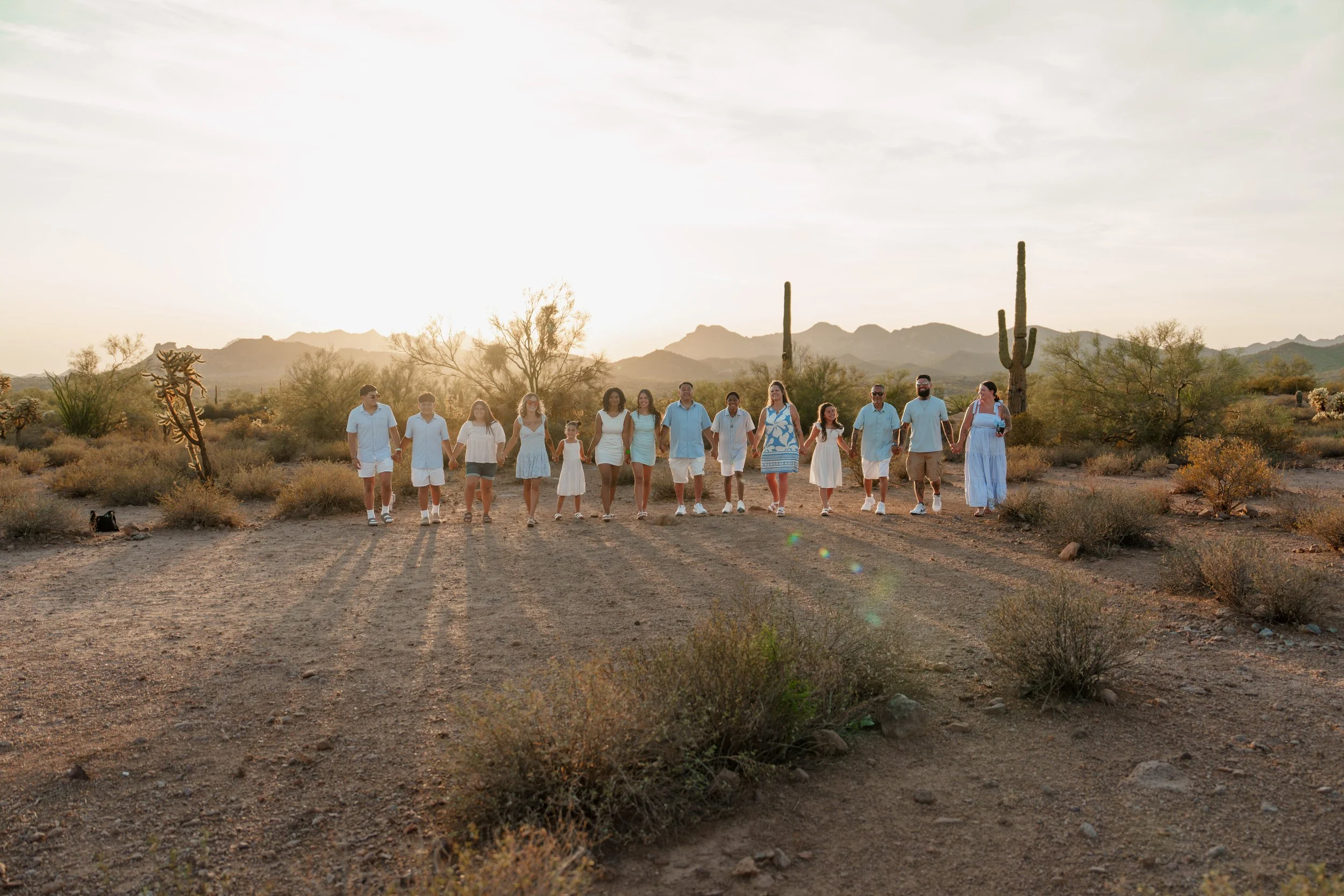 Extended family walking together through the Arizona desert during sunset