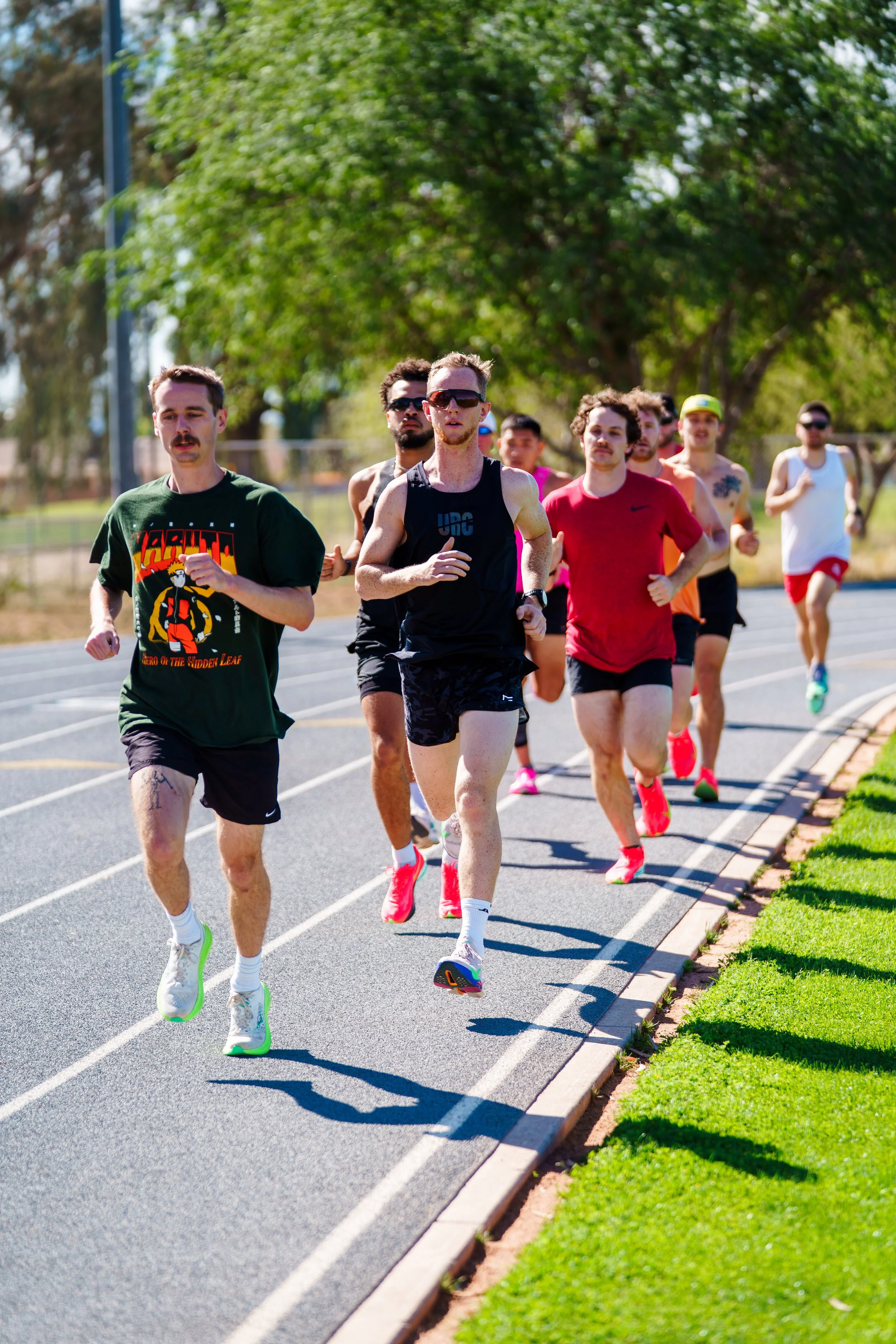 Runner standing with athletes gathered behind her before the Project PR running event