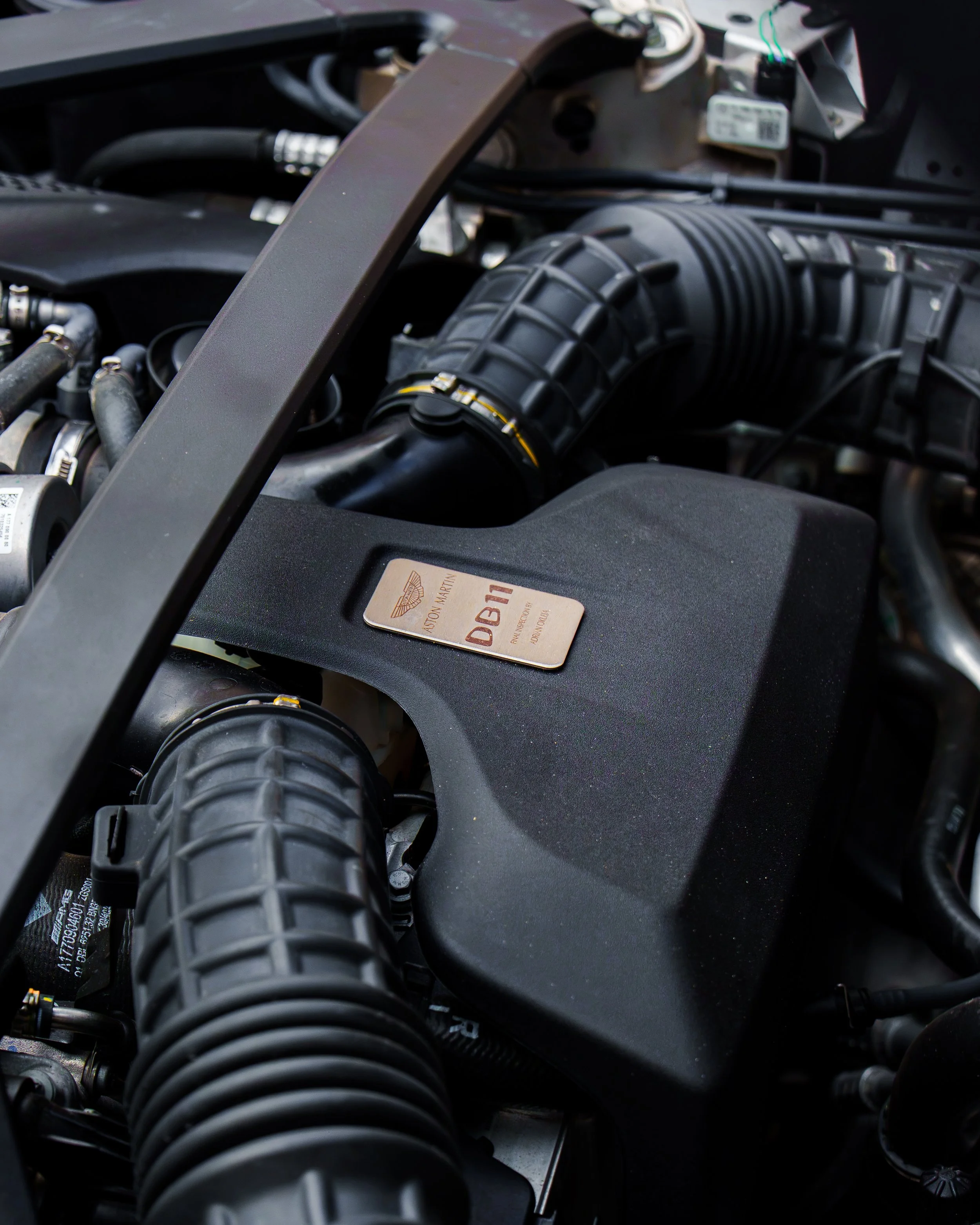 Close-up of the engine compartment and Aston Martin DB11 engine cover
