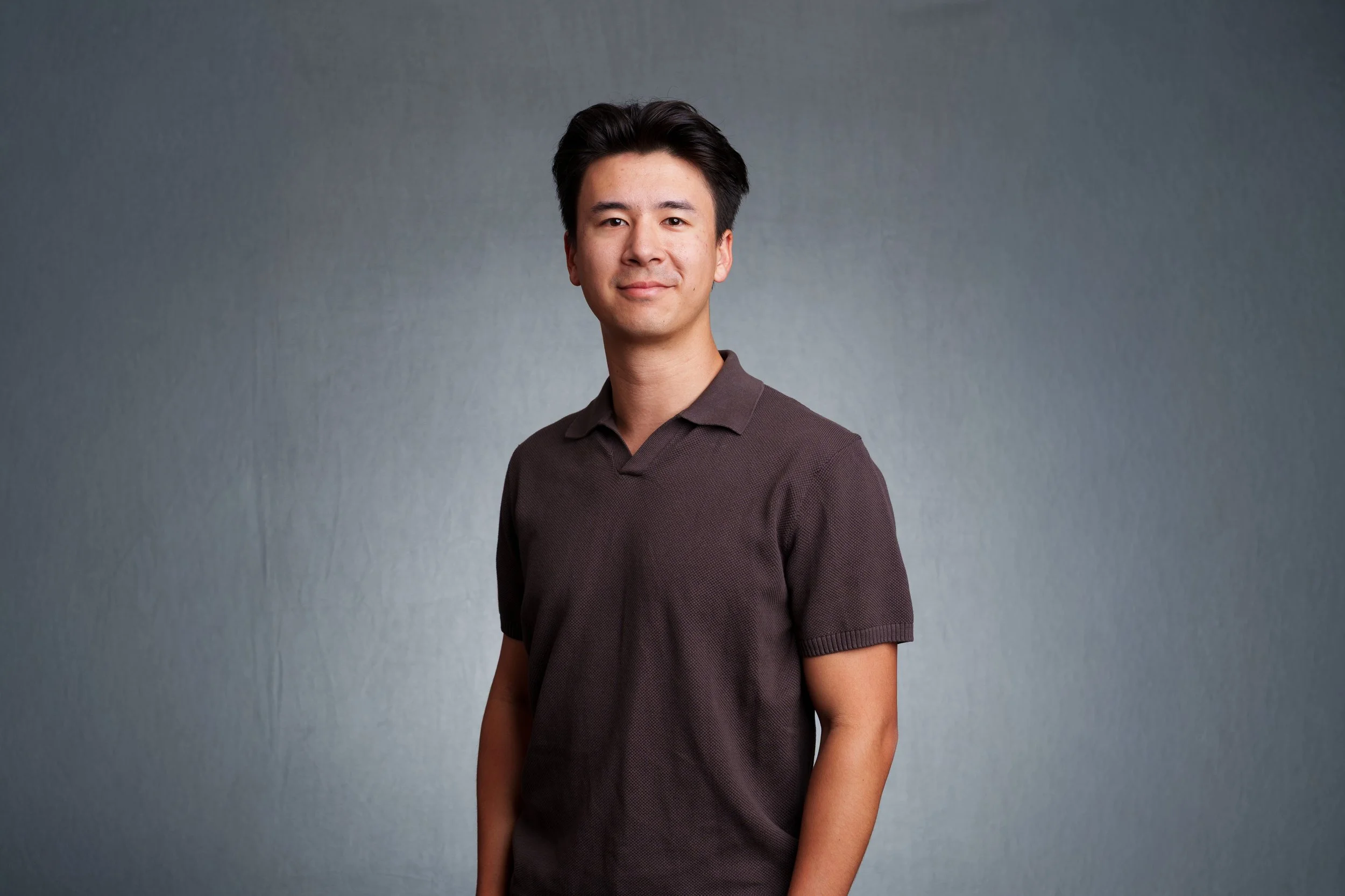Professional headshot of a man photographed with studio lighting against a neutral gray background in Scottsdale.