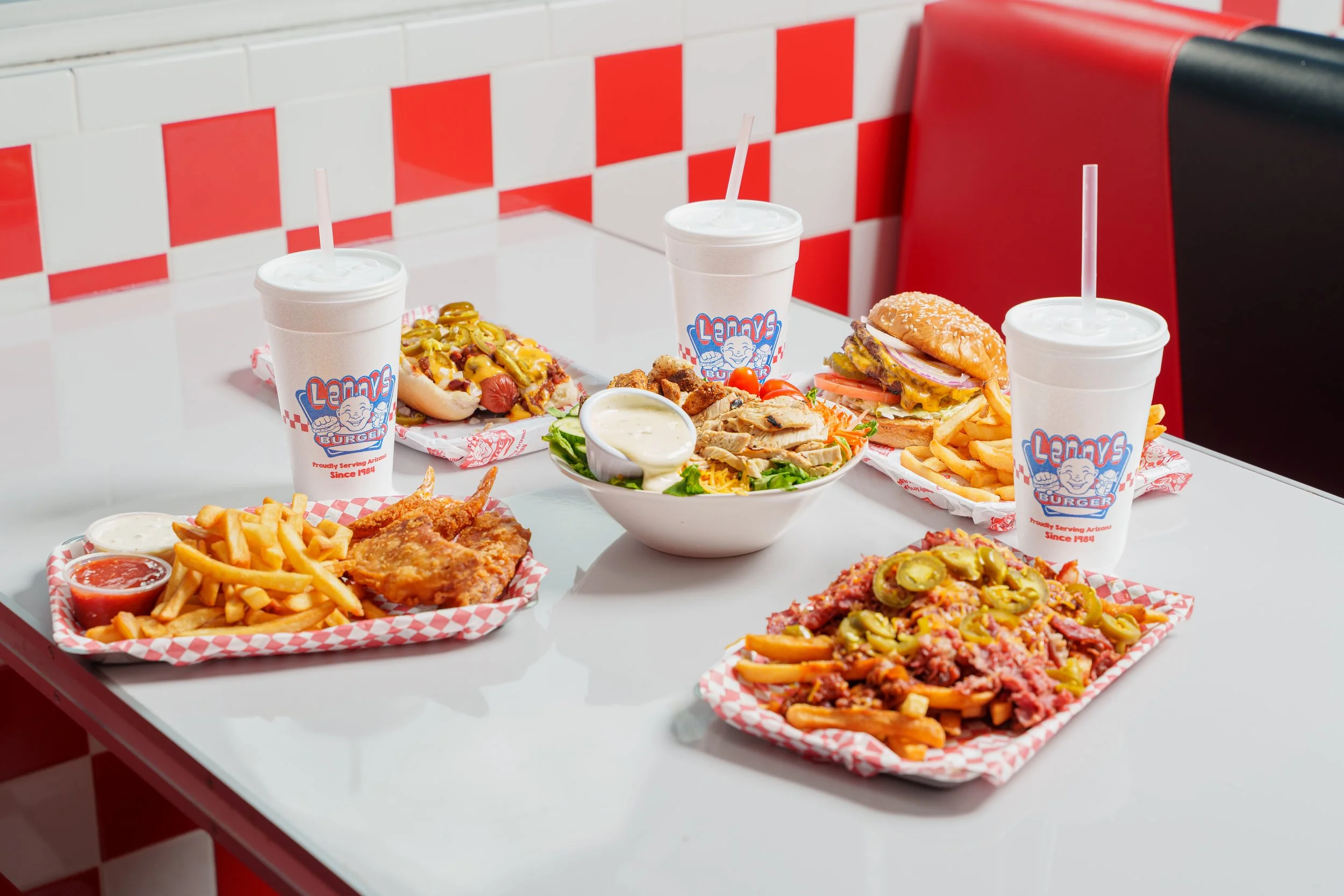 Lenny's Burger restaurant menu spread with burgers salad hot dogs fries and branded drinks