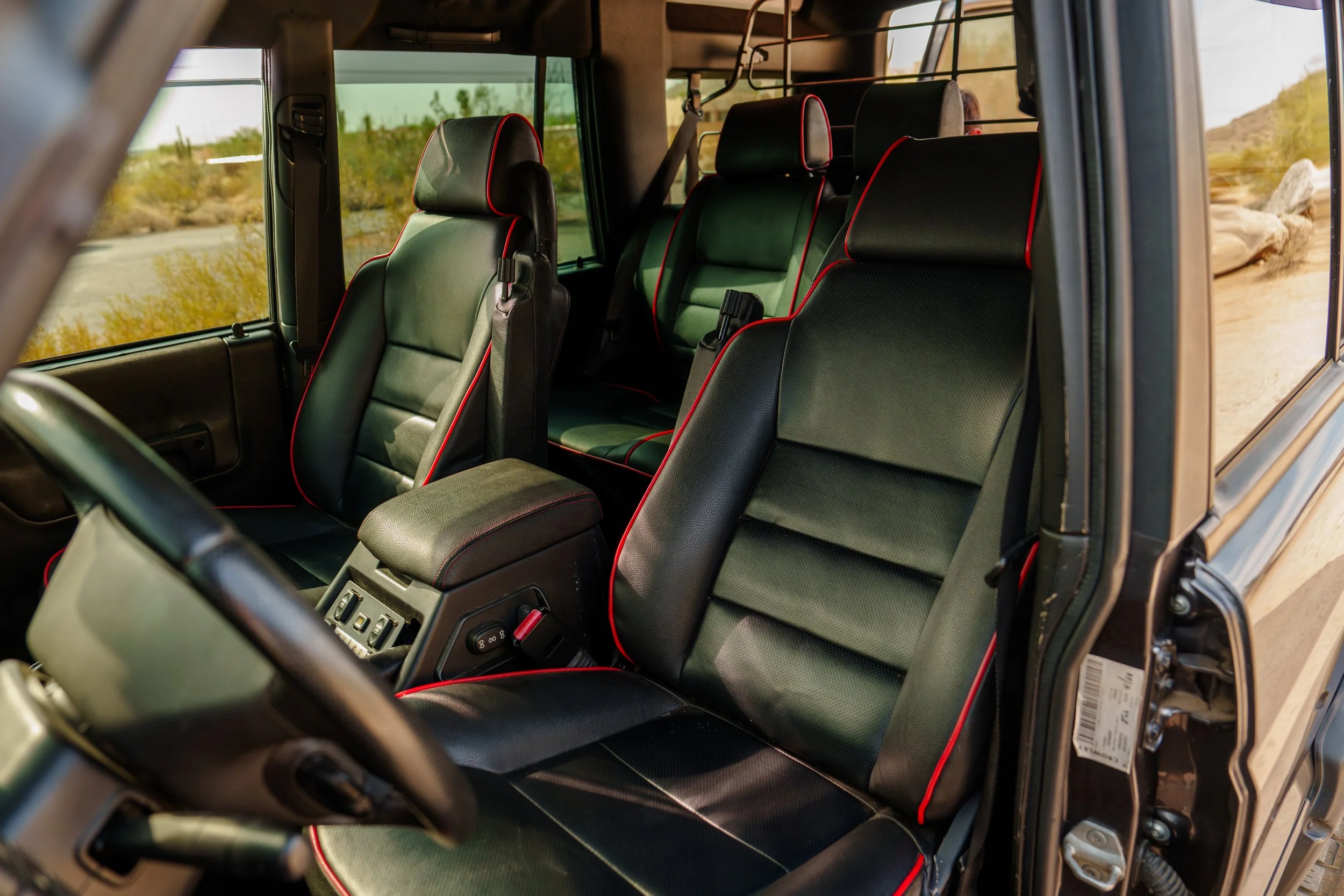 Black Land Rover Discovery II interior with red-piped front and rear seats