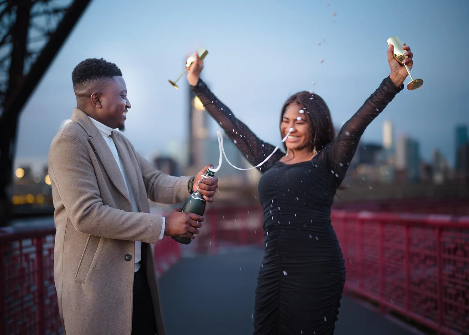 Silhouette of engaged couple against Chicago skyline at sunset