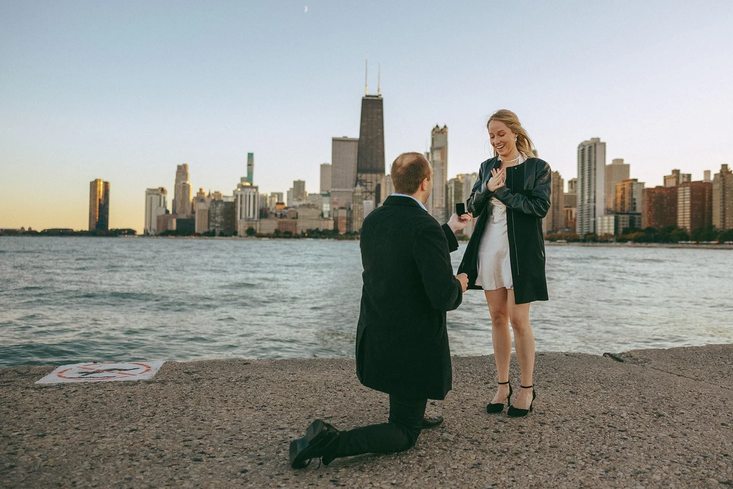 Marry Me sign reveal during elaborate Chicago bridge proposal with skyline backdrop