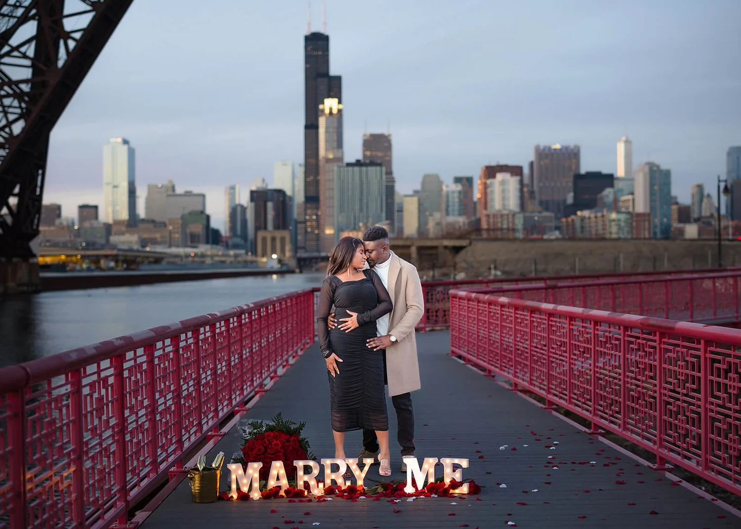Surprise beach proposal in Chicago with couple on sand and skyline in background