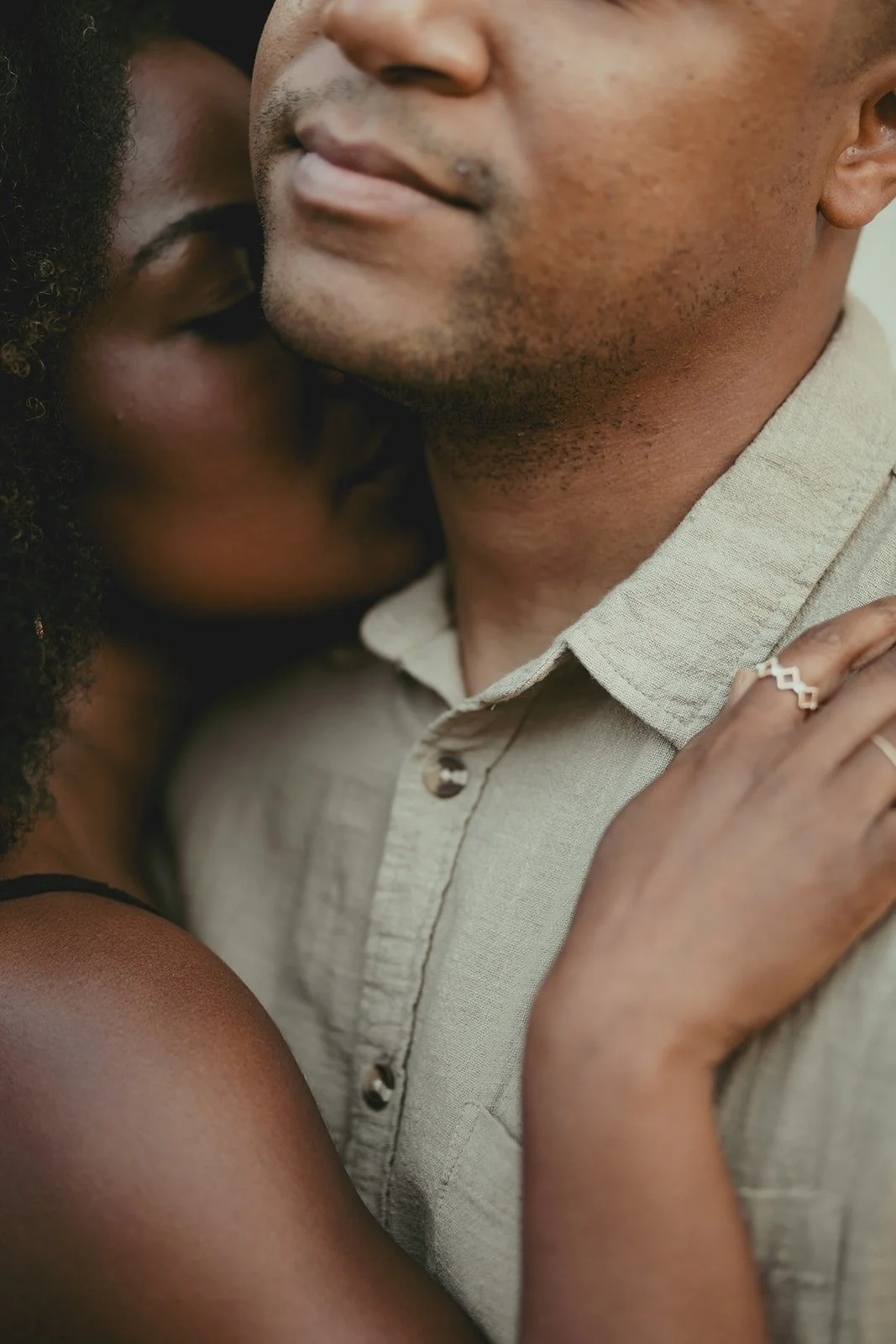 Couple silhouette against industrial backdrop during editorial engagement session