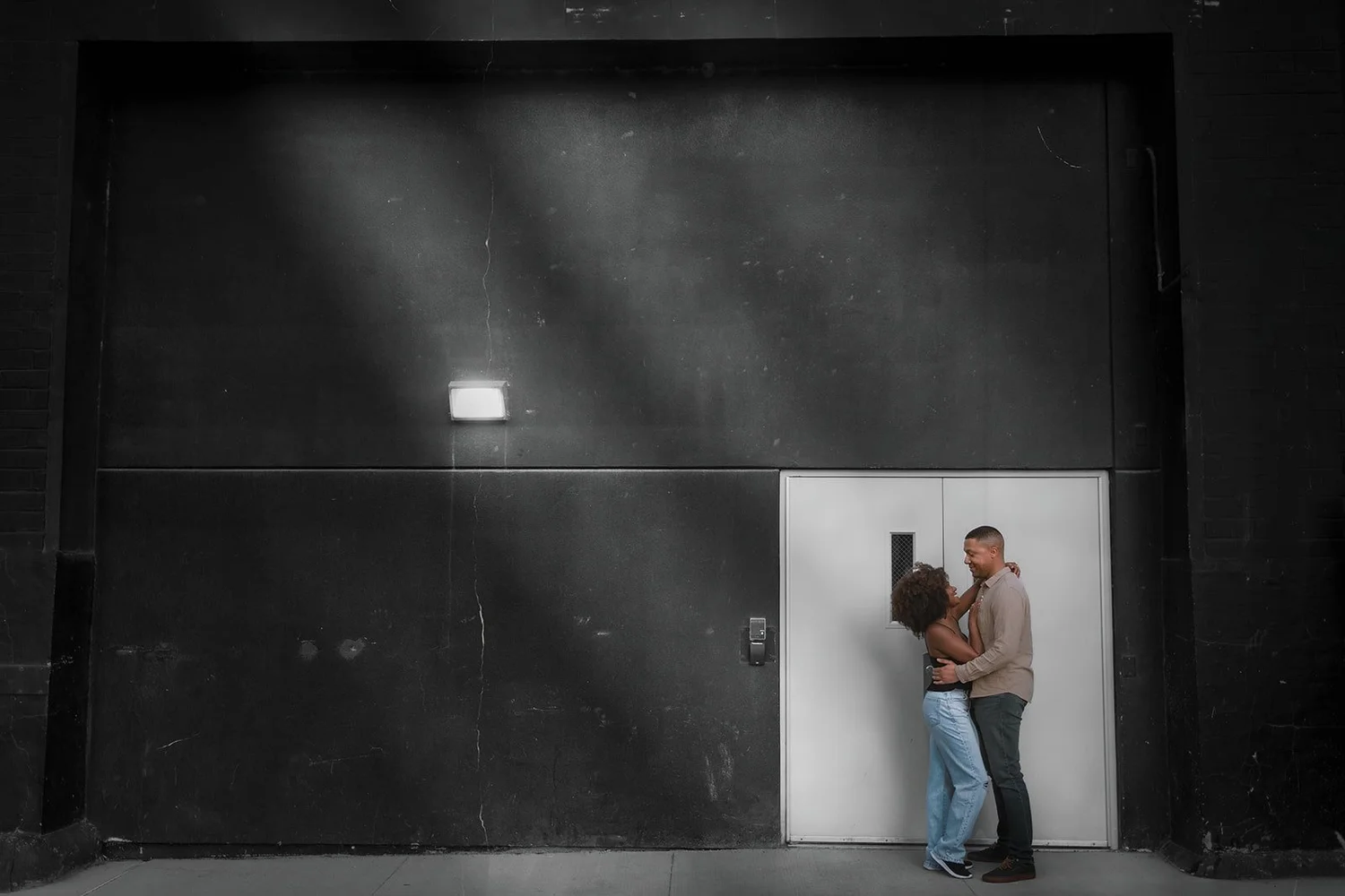 Cinematic couple portrait with moody industrial Chicago backdrop