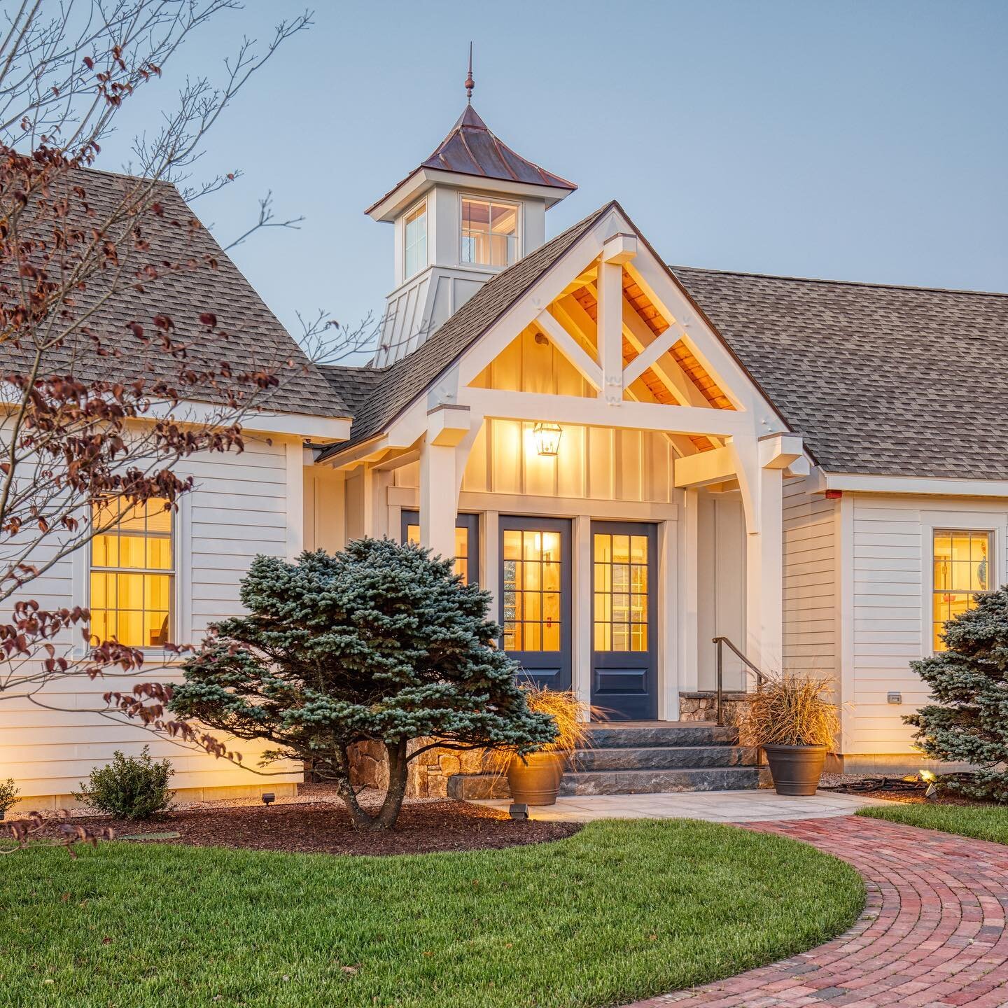 I love this beautiful, wooden entryway custom-designed for @landscapecreationsri &bull; Shot for @cordtsendesignarchitecture 

#architecture #architecturephotography #entrywaydecor #doordecor #twilightphotography #cupula #portico