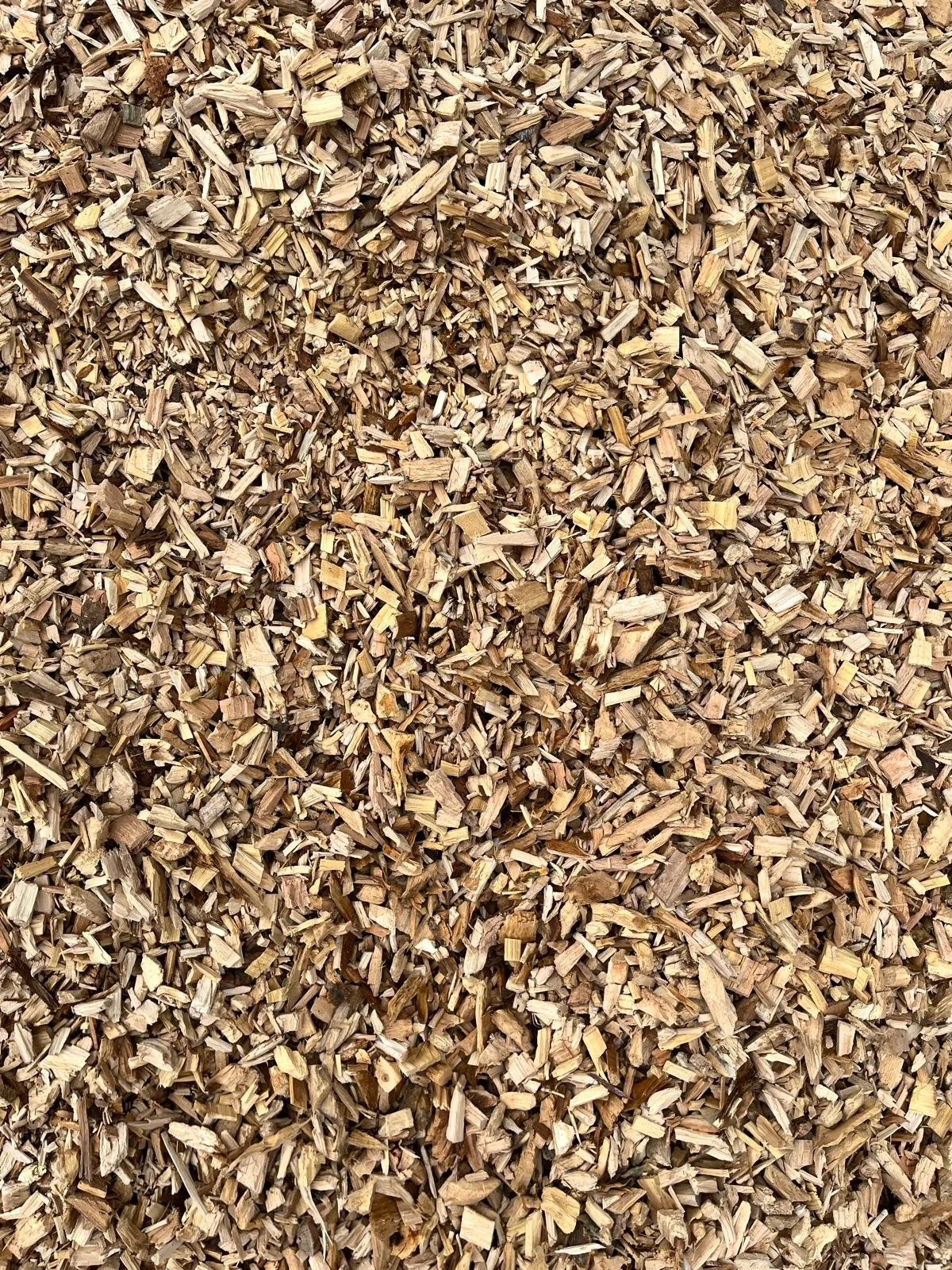 Close-up view of a large pile of wood chips or mulch.