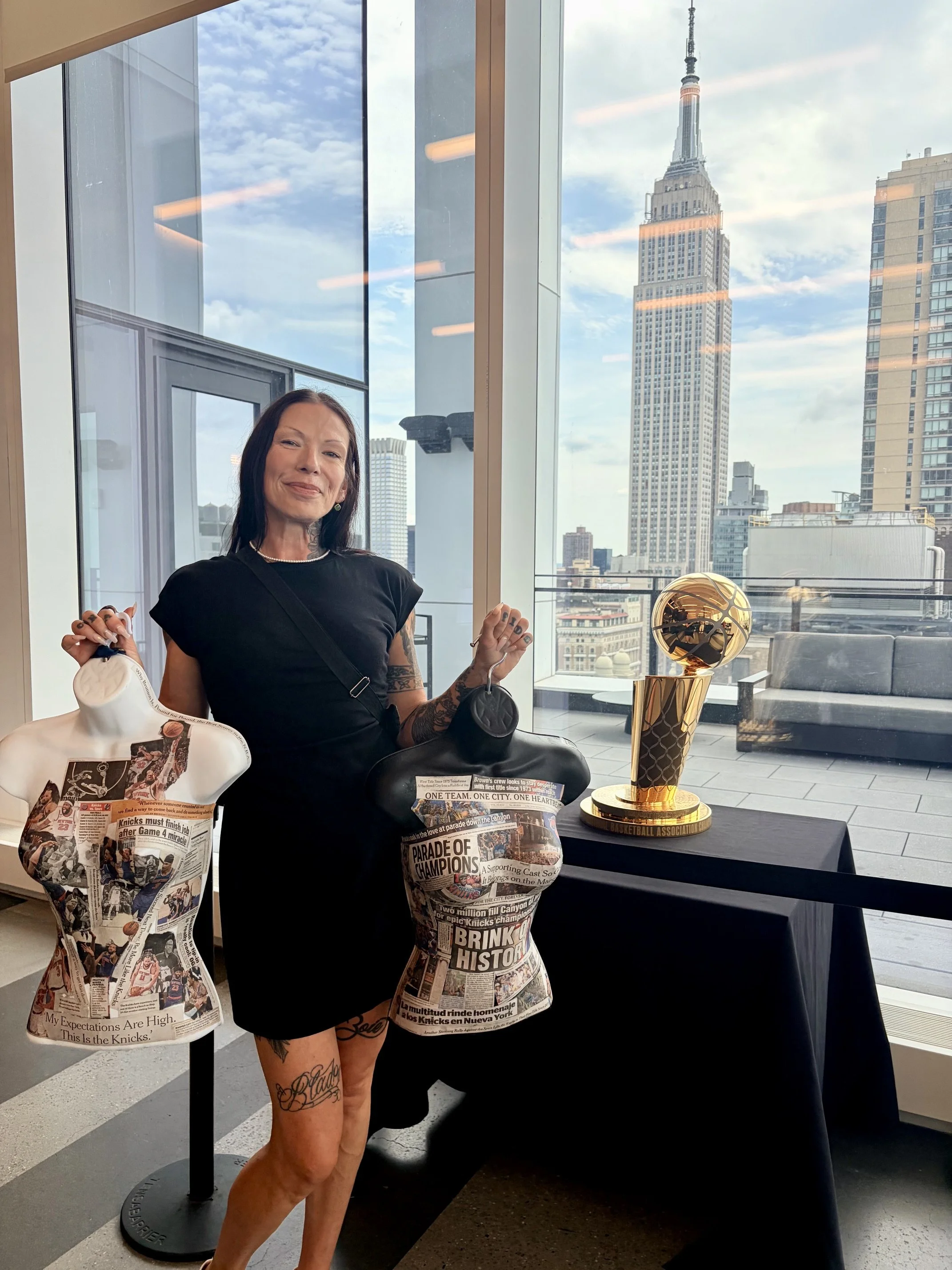 Contemporary artist Tania Scott with her sculptural Time Capsules, New York Knicks championship sculptures, and the Empire State Building in New York City.