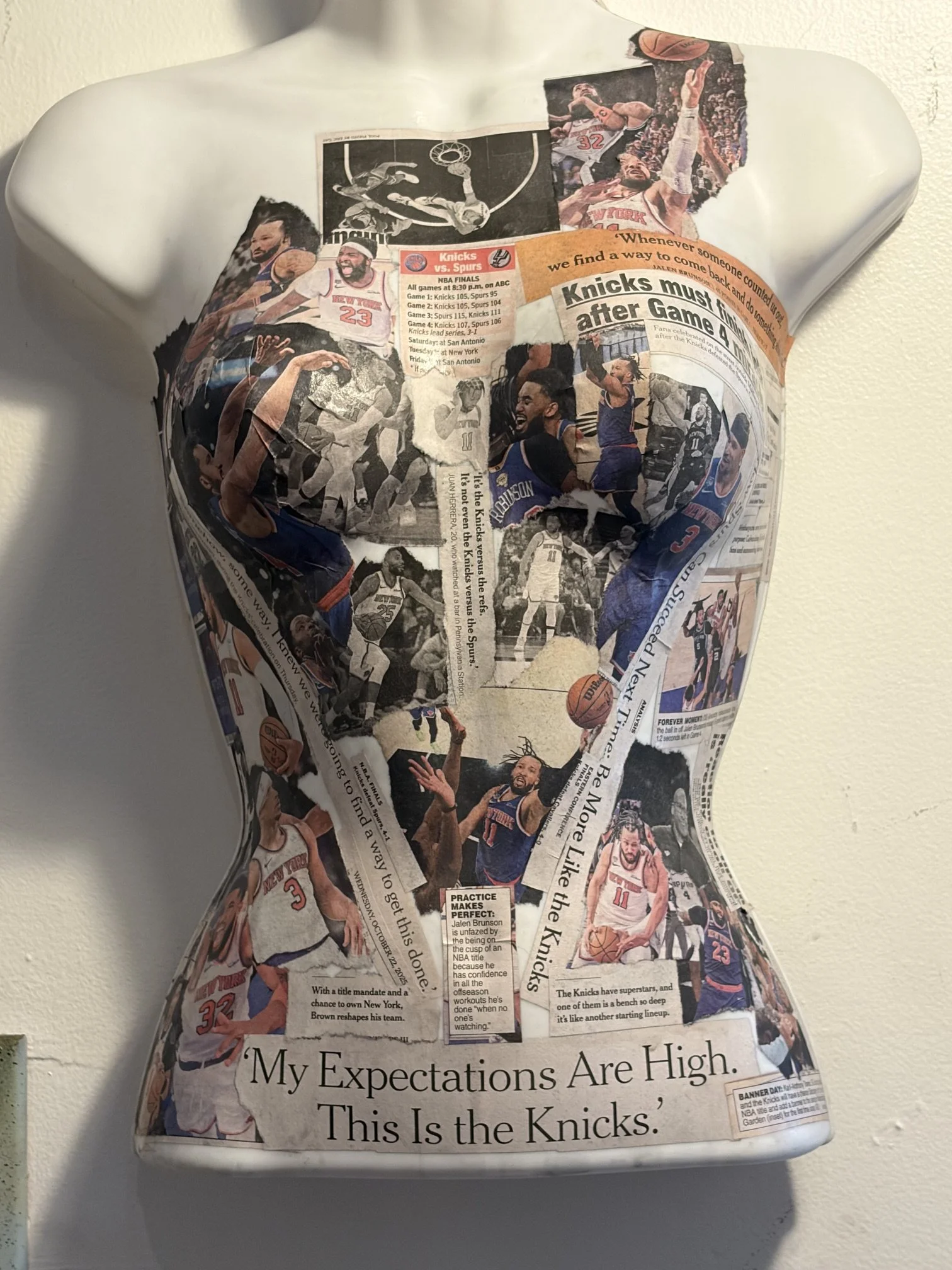 A full-length Time Capsule sculpture created from authentic New York Times newspapers documenting the Knicks' championship season. Featuring the players, defining headlines, and pivotal moments from the playoffs through the Finals, the work preserves
