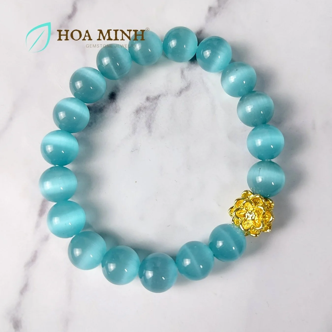 Vòng tay phong thủy đá Mắt Mèo màu xanh biển size hạt 10 li phối charm hoa sen xi mạ