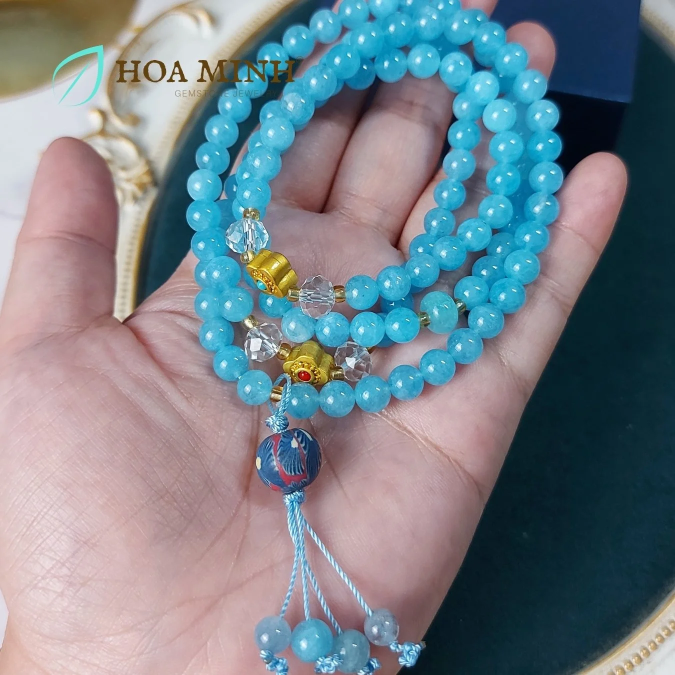 7-vong-tay-108-hat-da-aquamarine-size-6-5-li-phoi-vien-thach-anh-trang-oval-cat-giac-charm-co-4-la-phong-cach-tay-tang-vien-dat-set-hoa-xanh-hoa-minh-gem.jpg