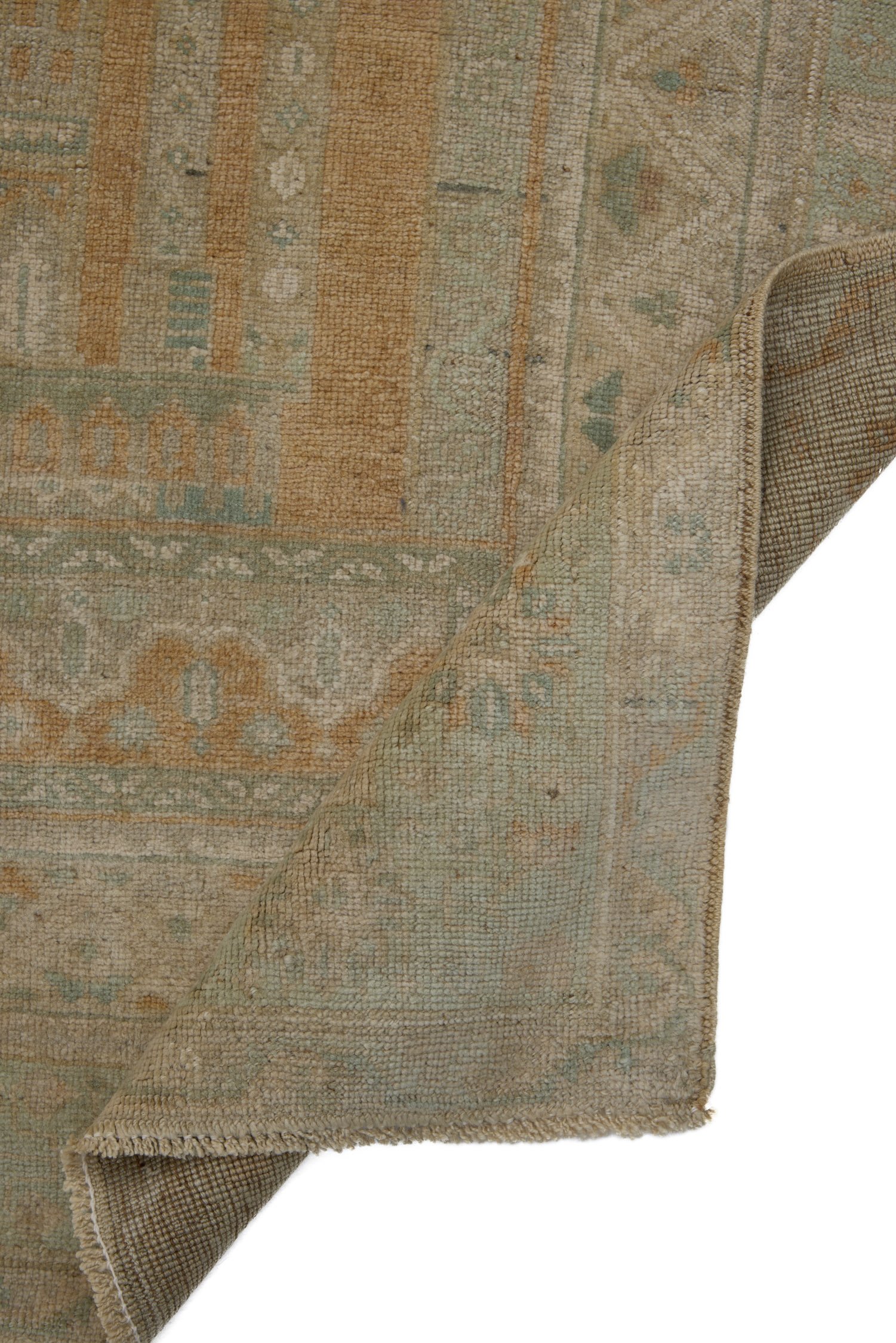 Corner of Turkish Kayseri rug folded to reveal construction