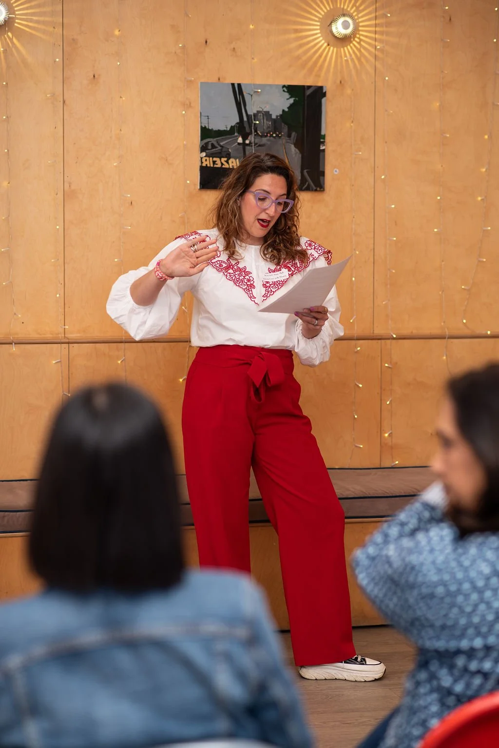 Horticultural therapist Kendall Marie Platt public speaking at Creative networking Berkshire event wearing red trousers and a white patterned blouse