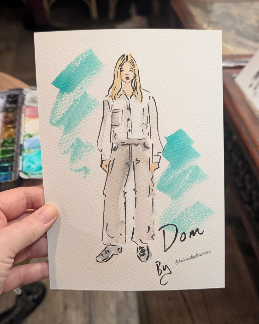 Watercolour portrait of a lady with blonde hair in workwear illustrated live by Helen Ridley