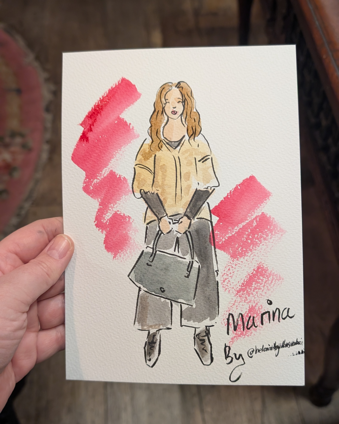 Custom watercolour portrait of a lady wearing a beige top and black trousers and holding a handbag illustrated by Helen Ridley