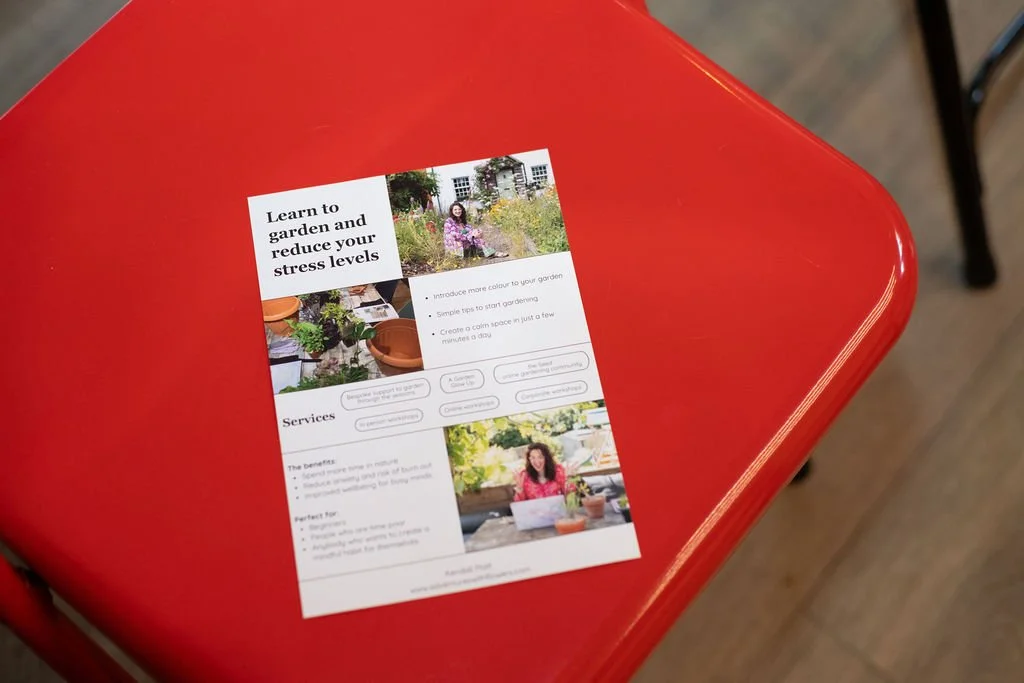 A promotional flyer sitting on a red table at the creative networking event in Reading