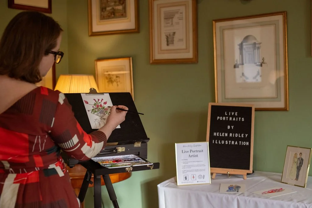 Illustrator Helen Ridley painting wedding florals in watercolour at an easel