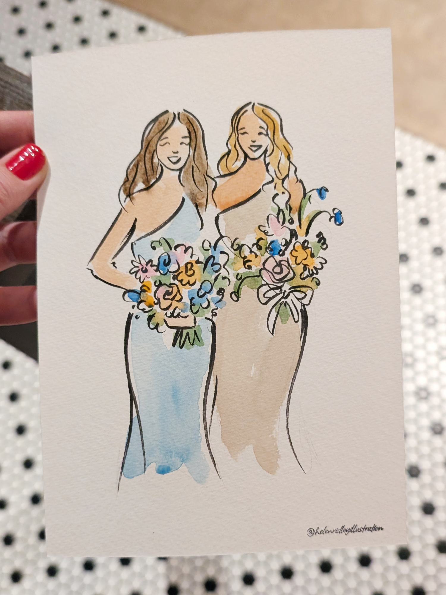 Two lady wedding guests wearing blue and cream dresses and holding floral bouquets