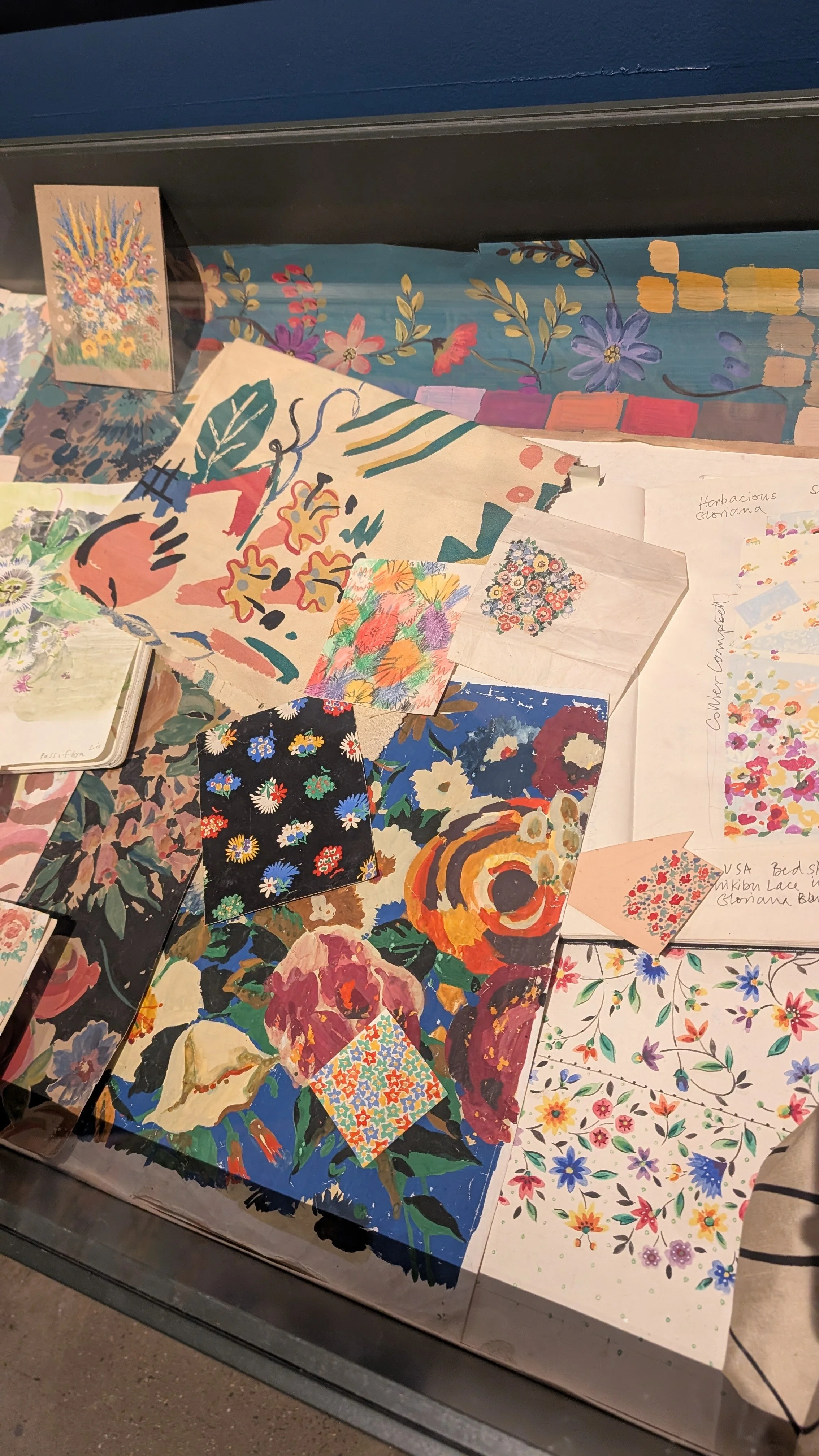 A collection of floral samples, painted paper, sketchbooks and prints at the Sarah Campbell Exhibition in London