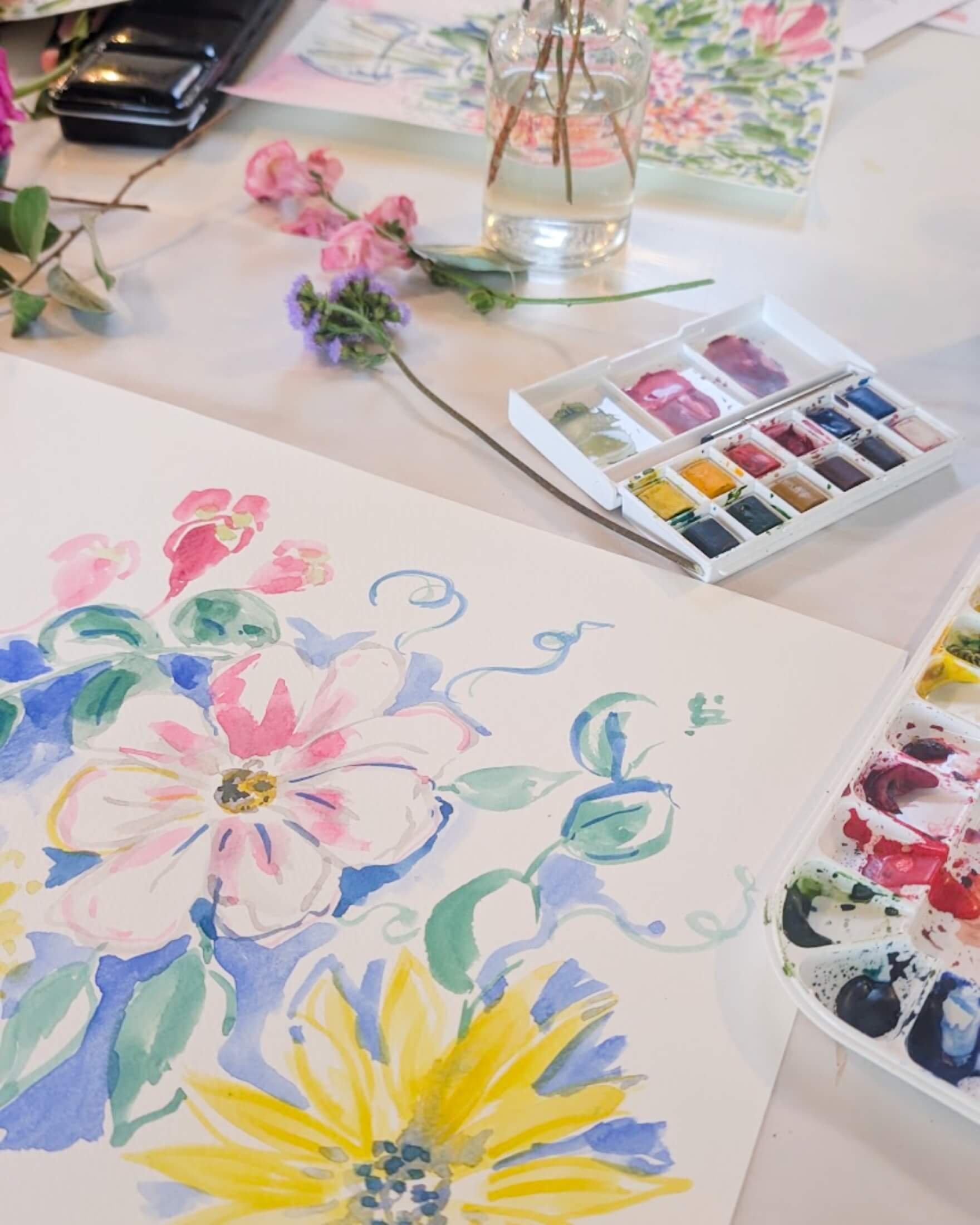 Watercolour kit and paintings of flowers